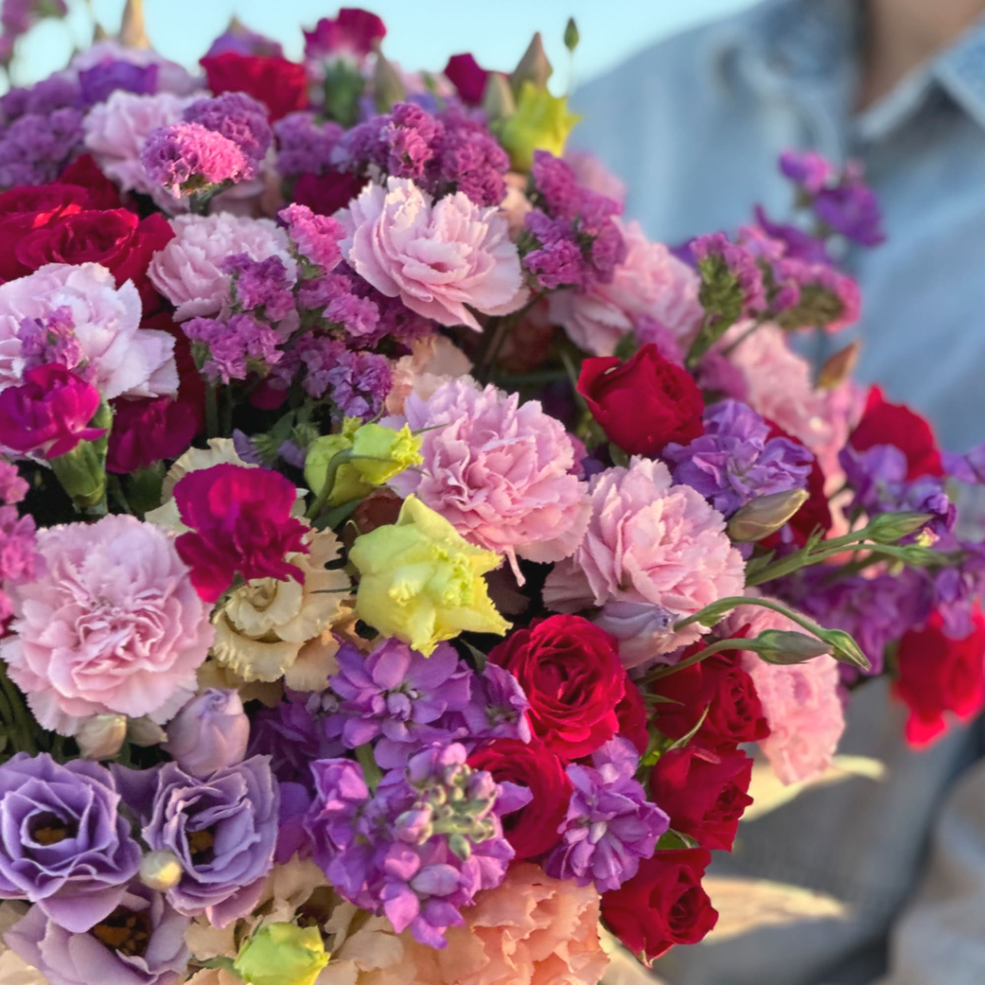 Mixed bouquet of pink, purple, and red flowers