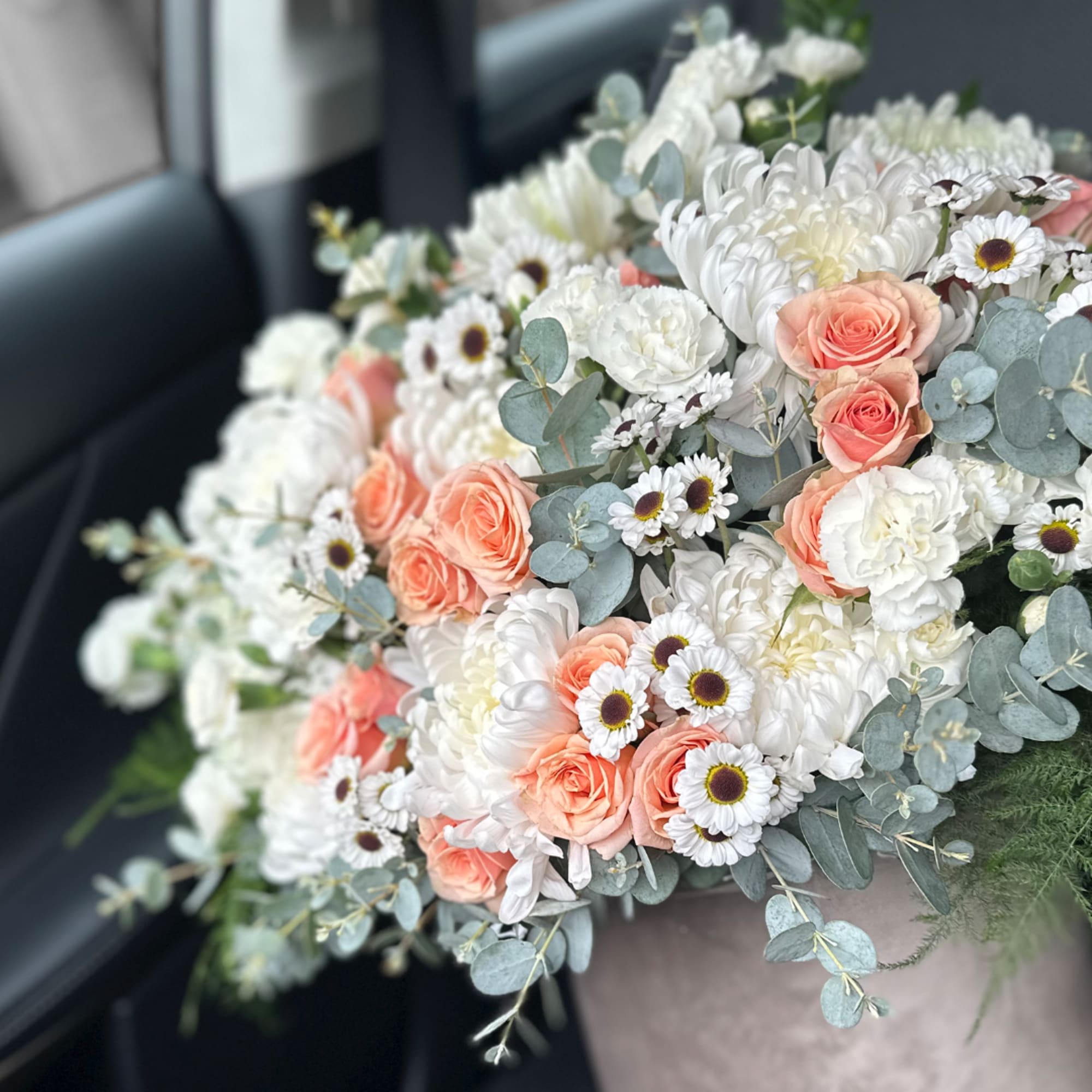 Bouquet of peach roses and white chrysanthemums with small daisies