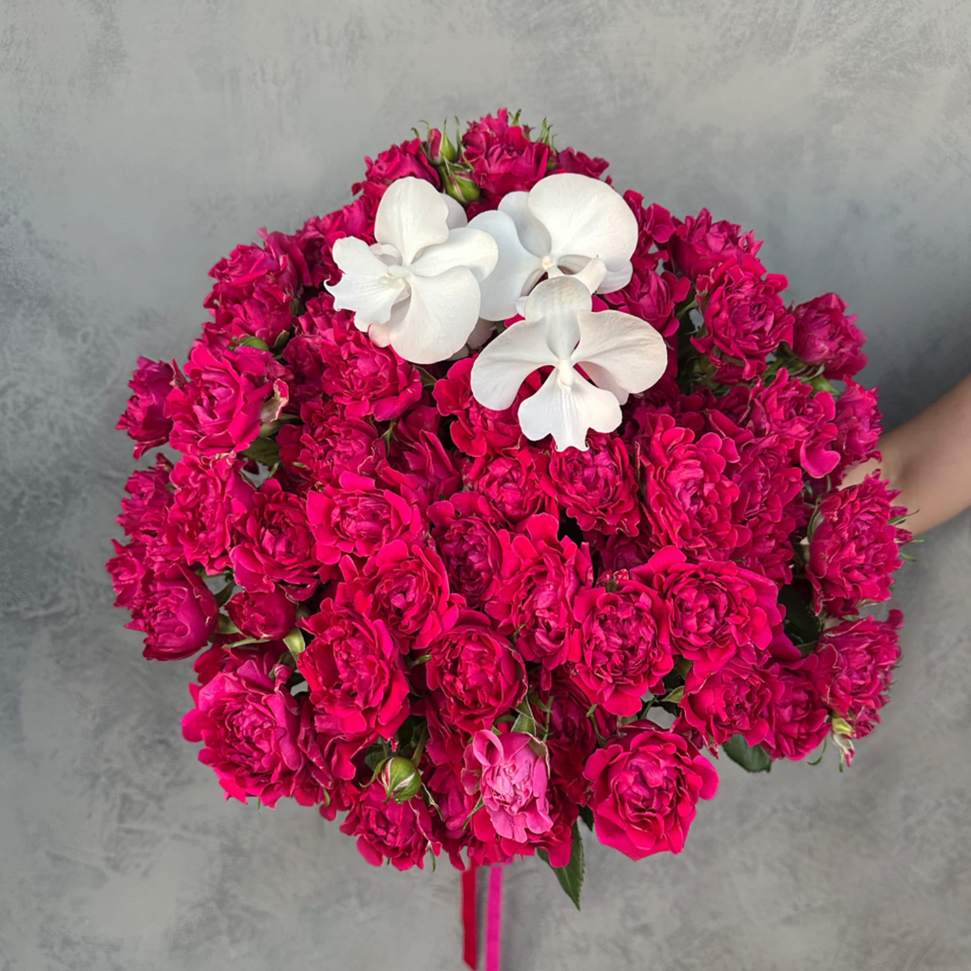 Bouquet of hot pink roses with white orchids