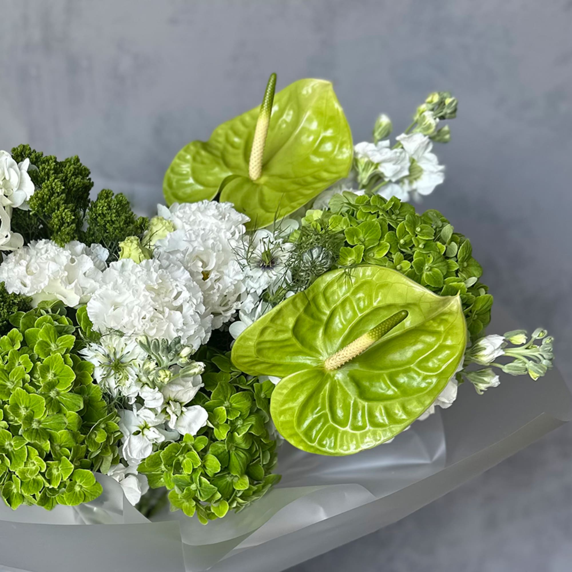 Bouquet with white flowers and bright green anthuriums