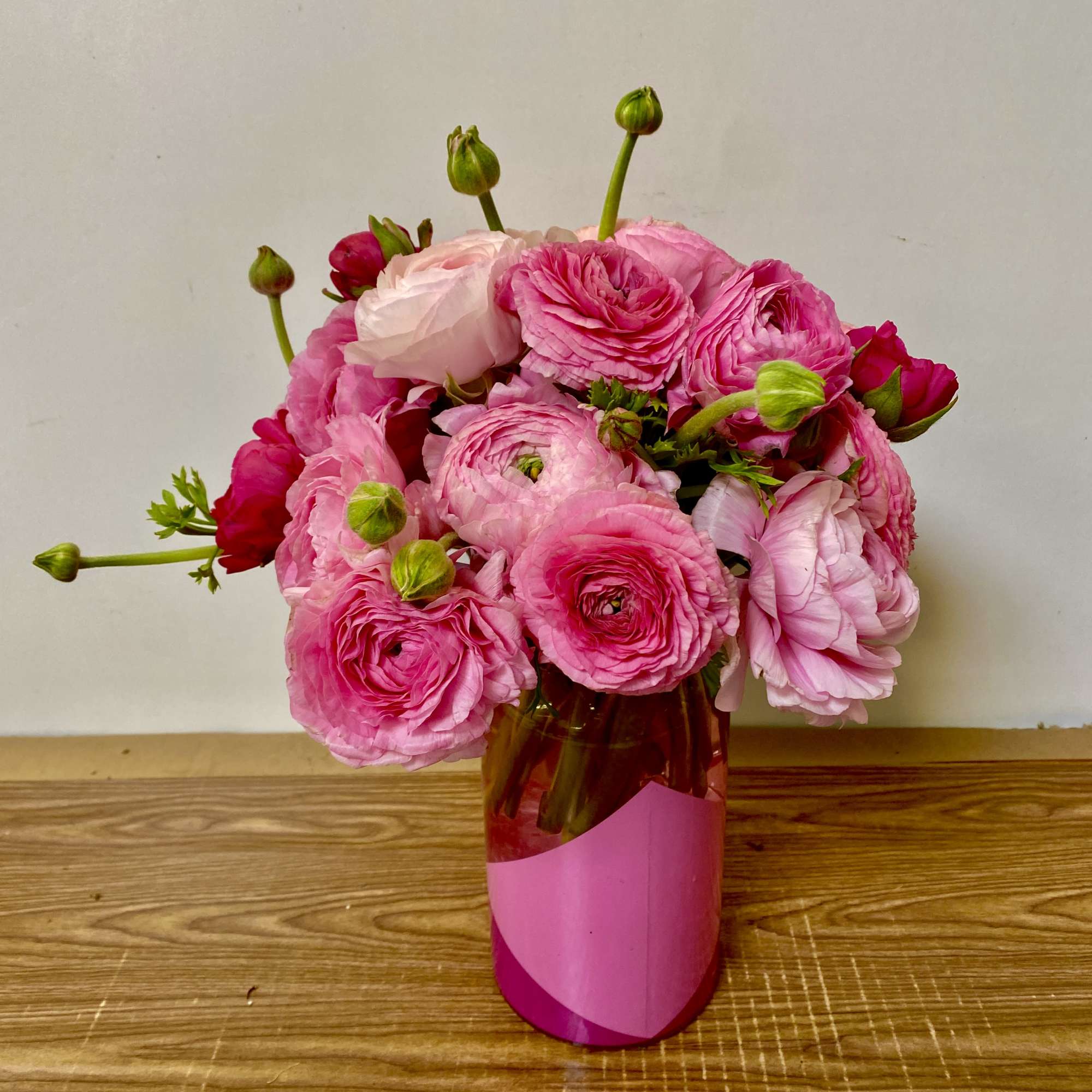 Pink ranunculus bouquet in a glass vase