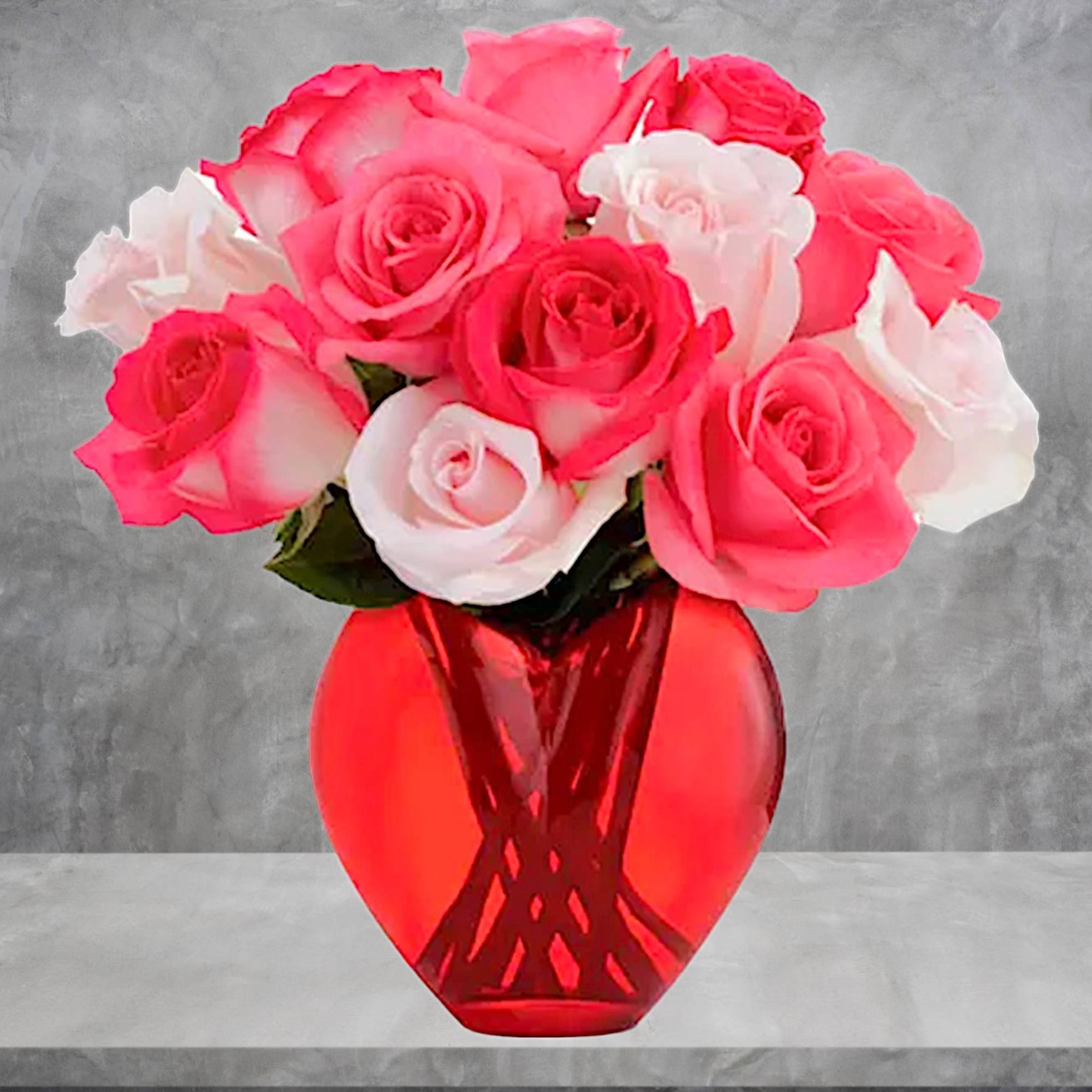 Pink and white roses arranged in a red glass vase, photo 2 of 4