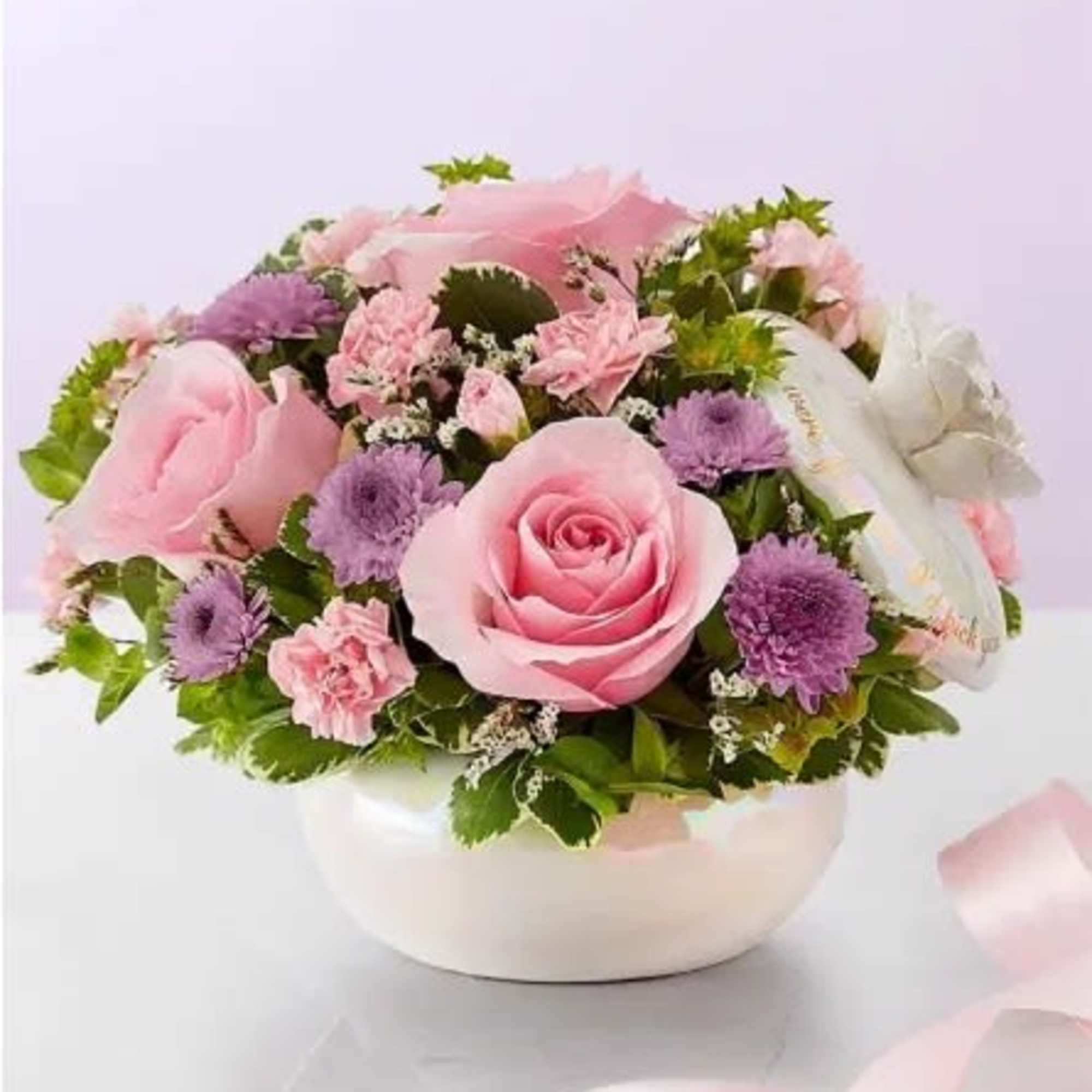 All-around arrangement with light pink roses and mini carnations, pink Limonium and