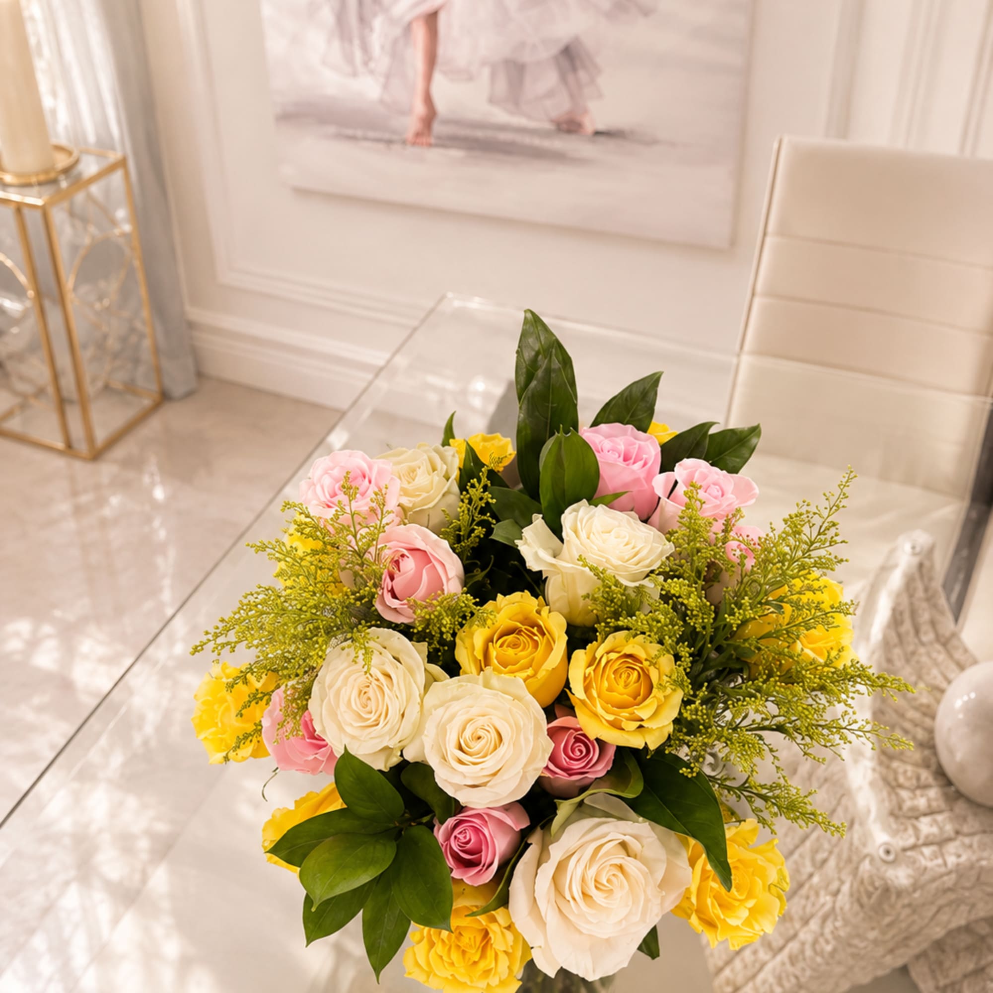 Bouquet of pink, white, and yellow roses in a clear glass vase