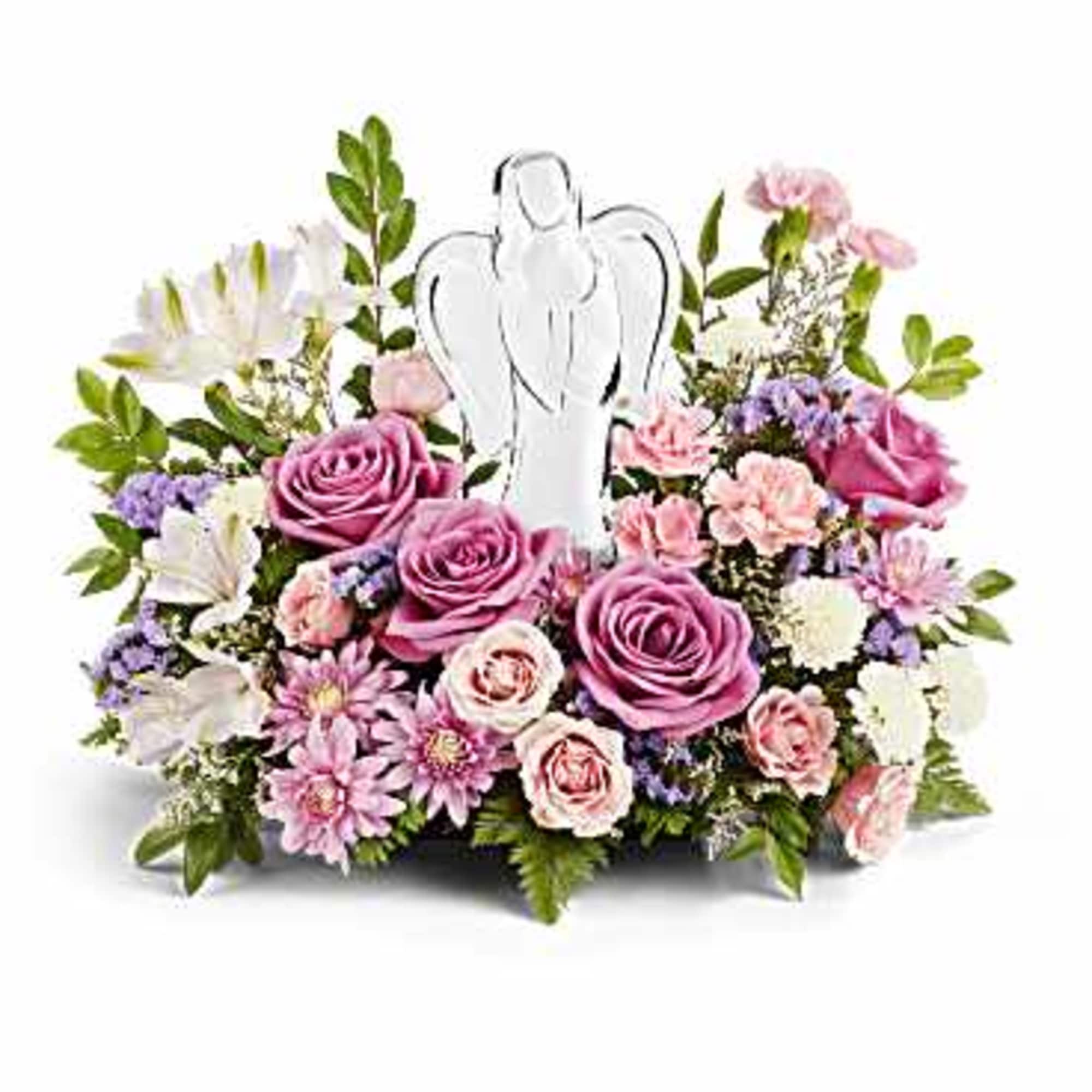Pink and white floral arrangement with an angel figurine