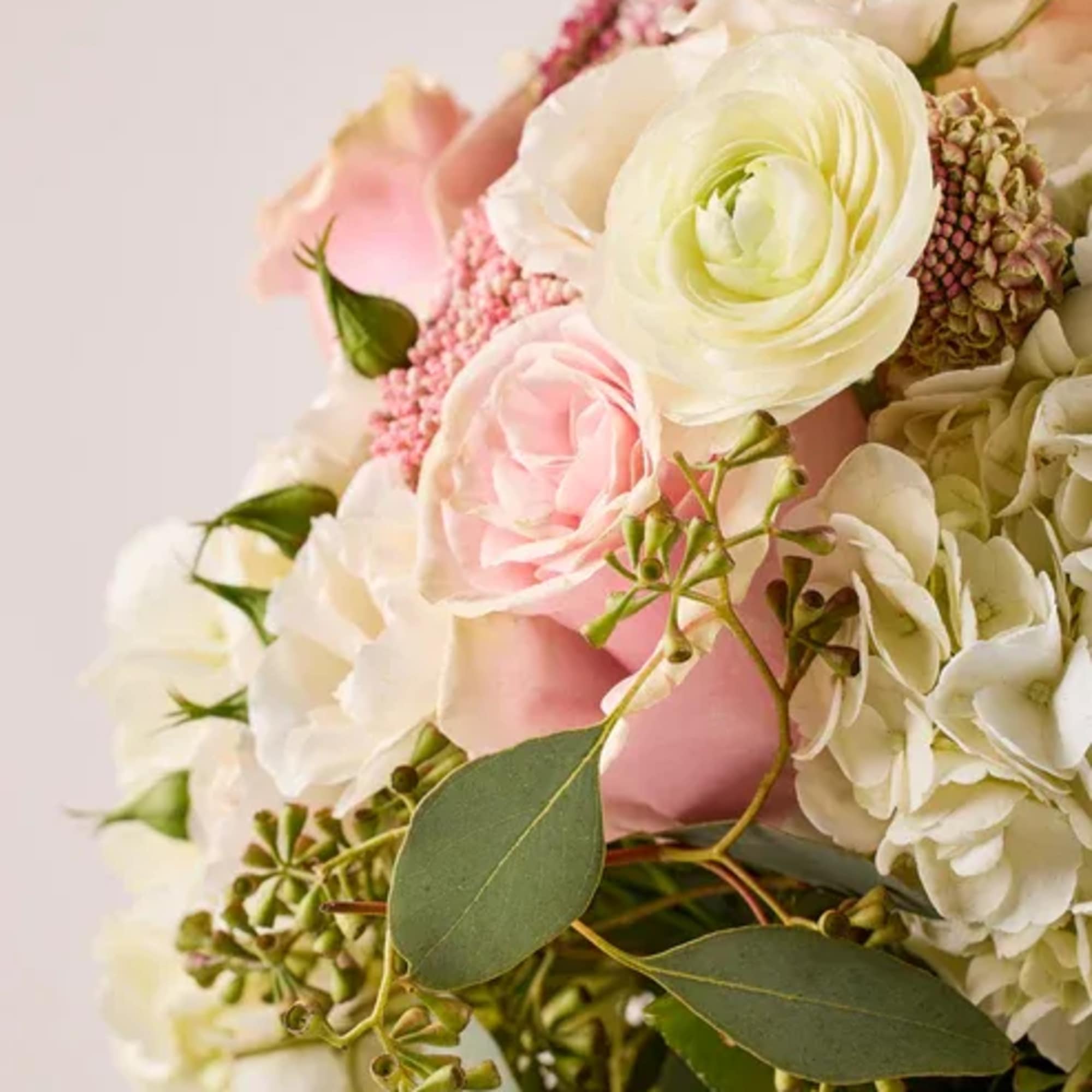 Bouquet of white and pink flowers with greenery