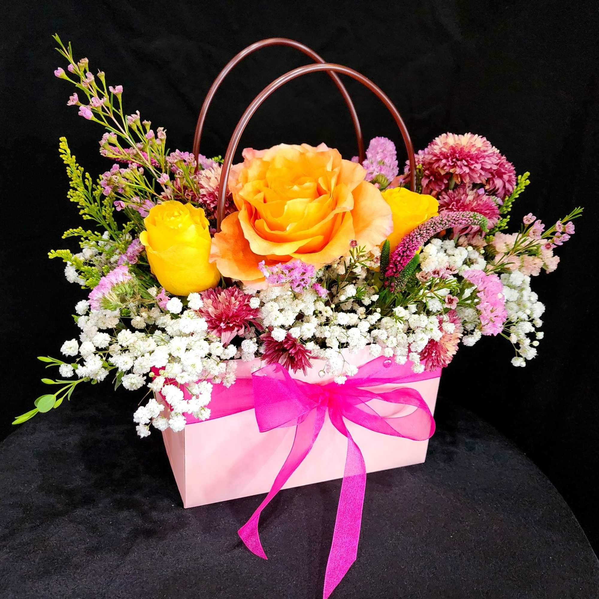 Surprise your loved one with this beautiful tote inspired arrangement with gorgeous