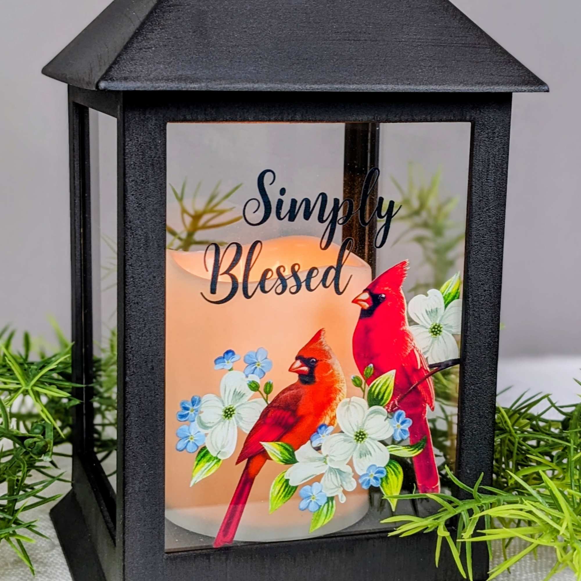 Black lantern with a candle and cardinal floral print