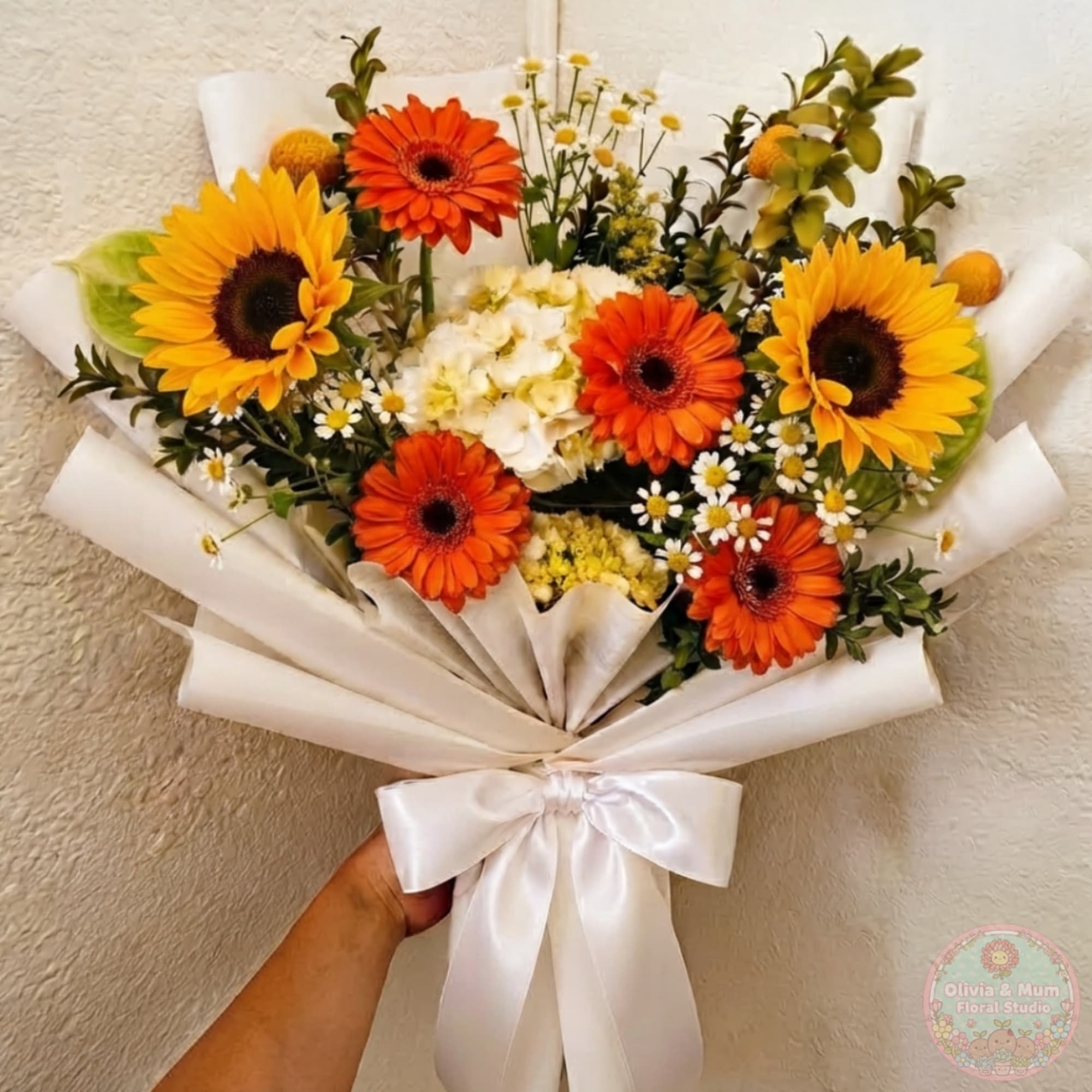 Bouquet of sunflowers and orange gerbera daisies wrapped in white paper