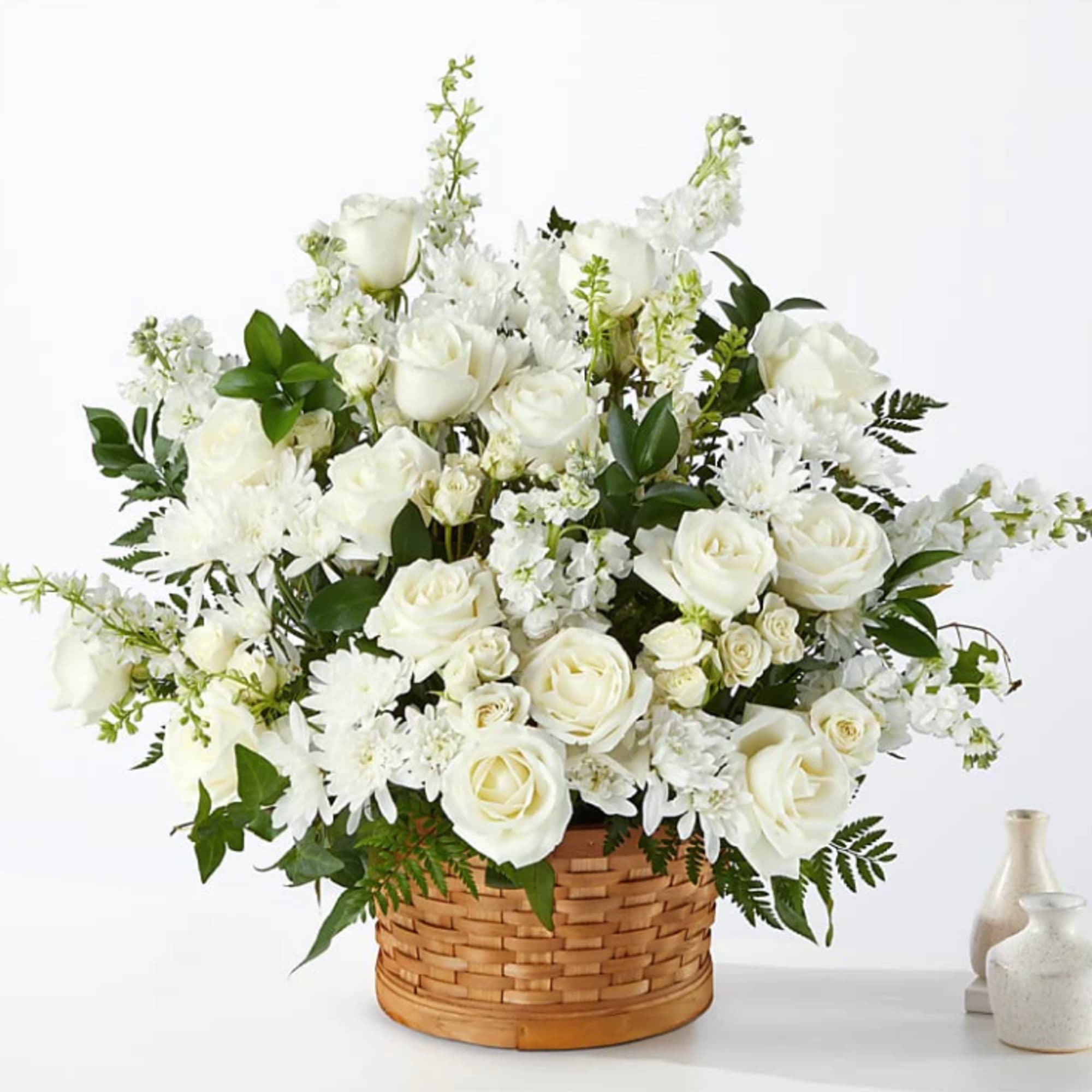Let this exquisite composition of beautiful white blossoms deliver your sympathy and