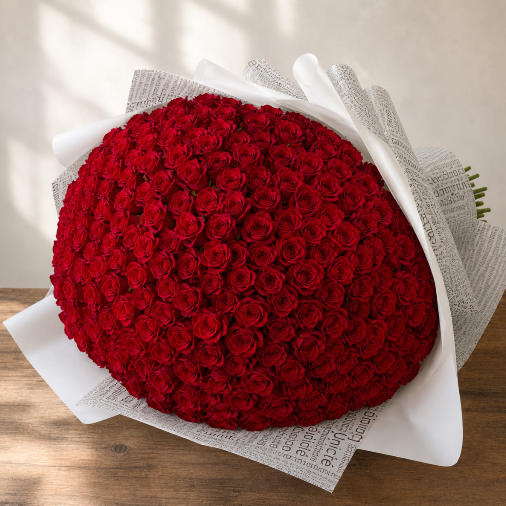Large bouquet of red roses wrapped in white paper