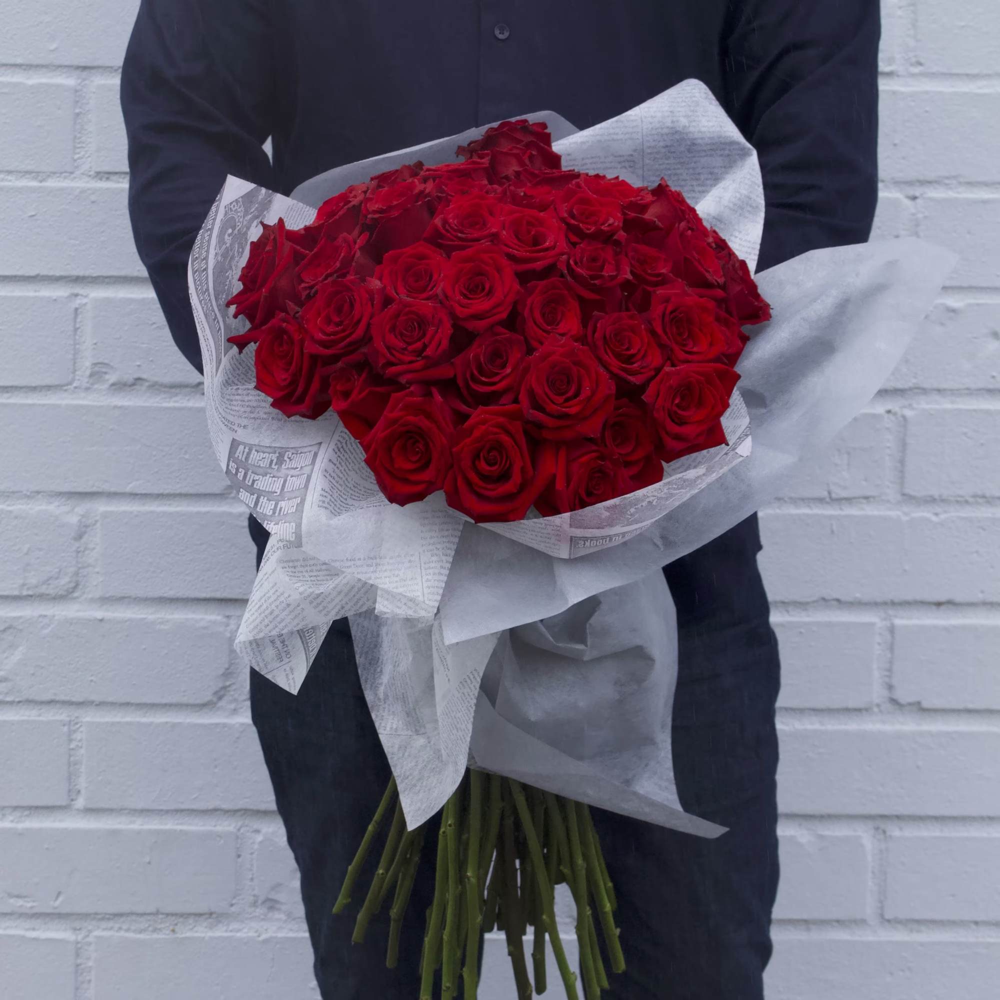 Large bouquet of red roses wrapped in white paper