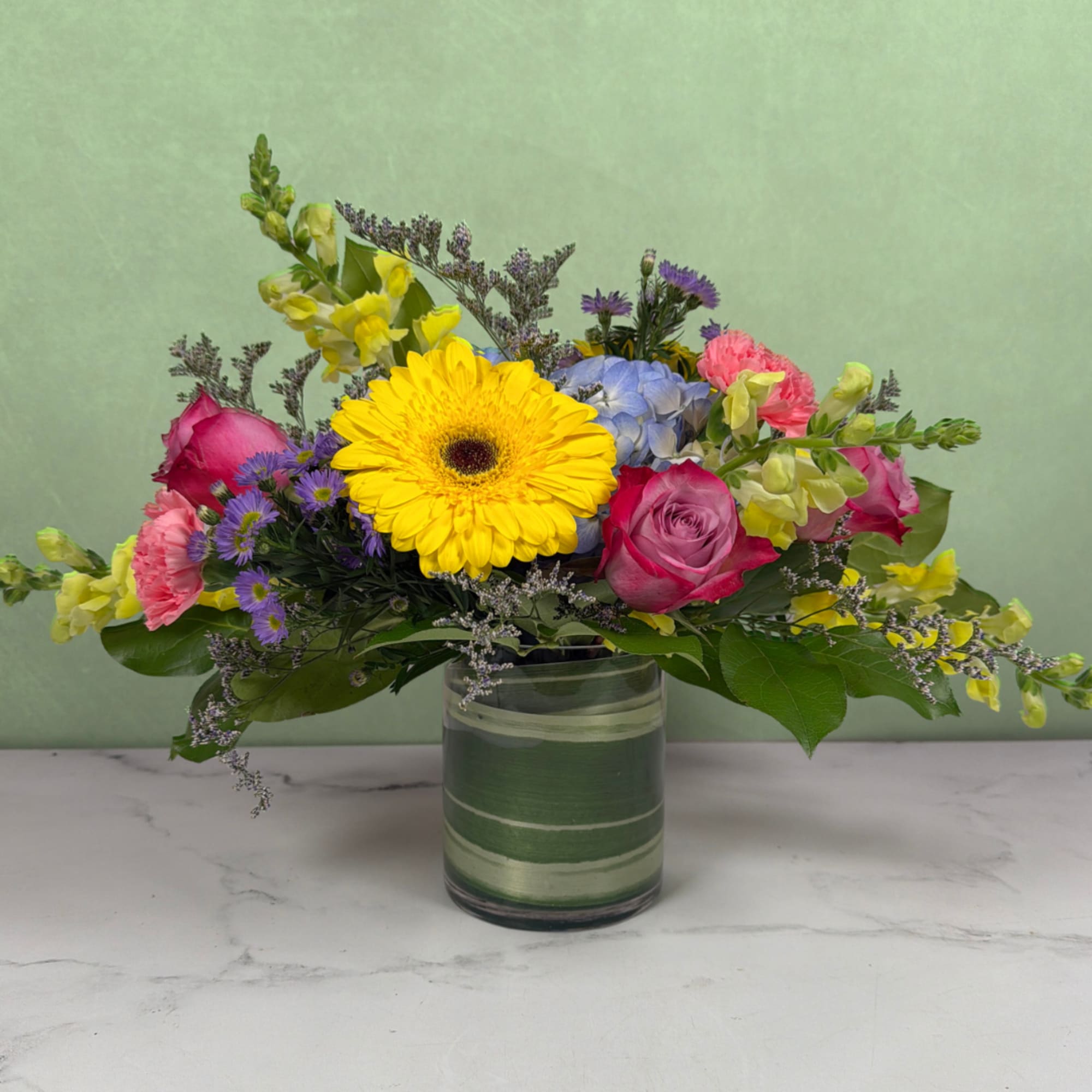 Colorful flowers are blooming in this Breath of Spring Cylinder by Savilles, photo 2 of 3
