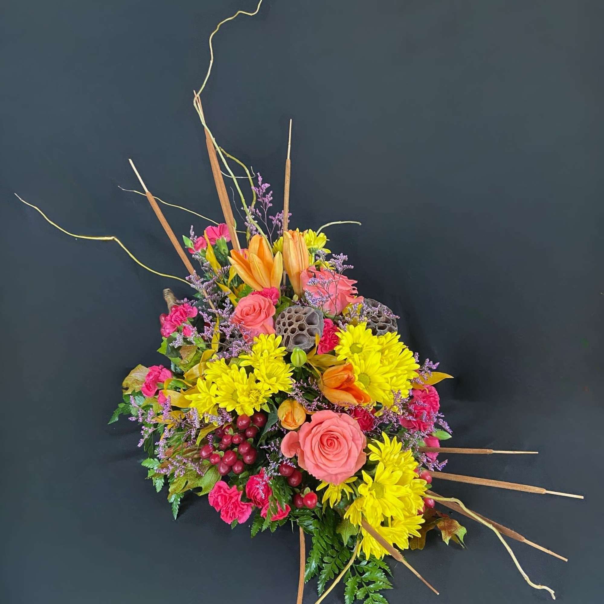 Bright mixed bouquet with yellow chrysanthemums, pink roses, and orange lilies