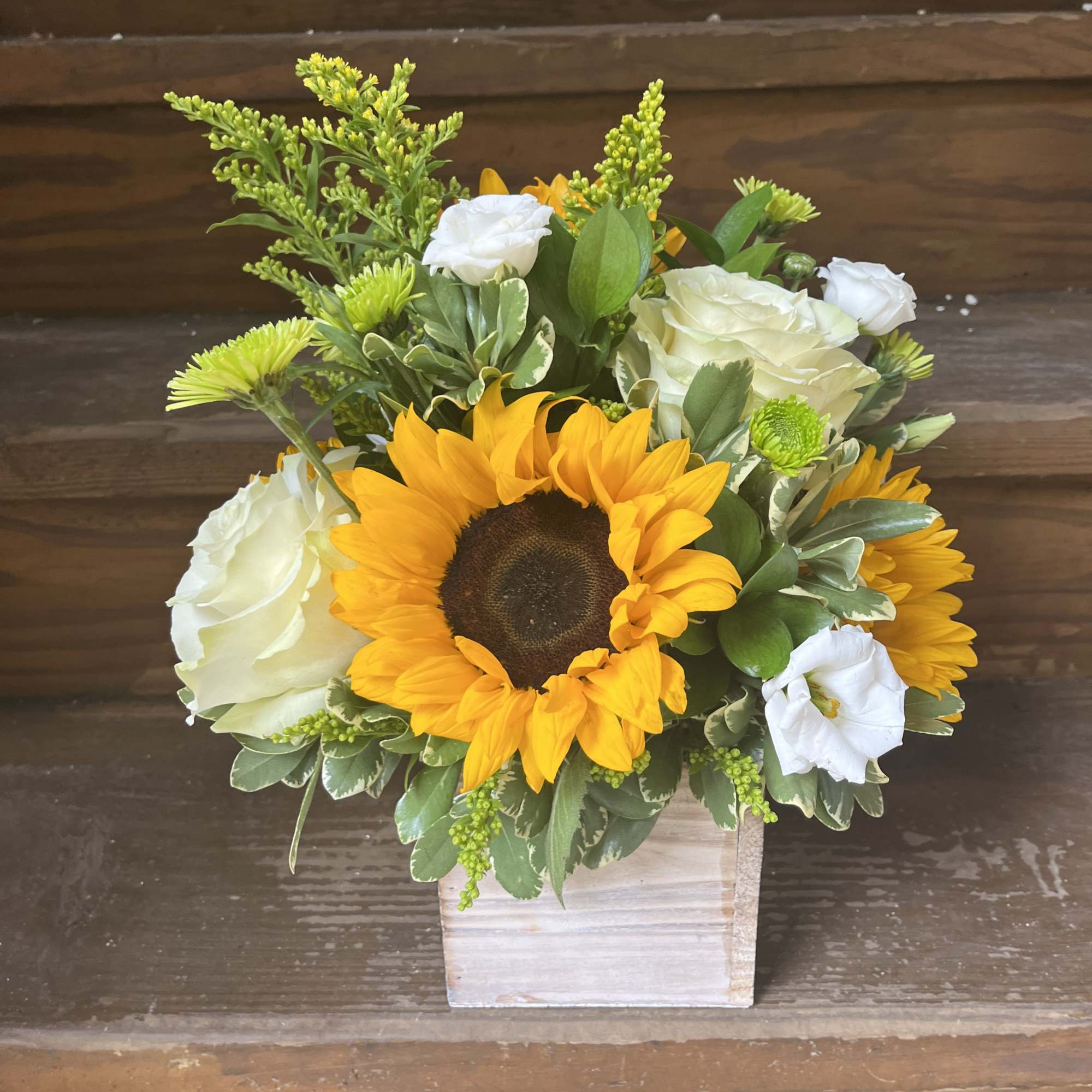 Sunflower and white rose arrangement in a square wooden container