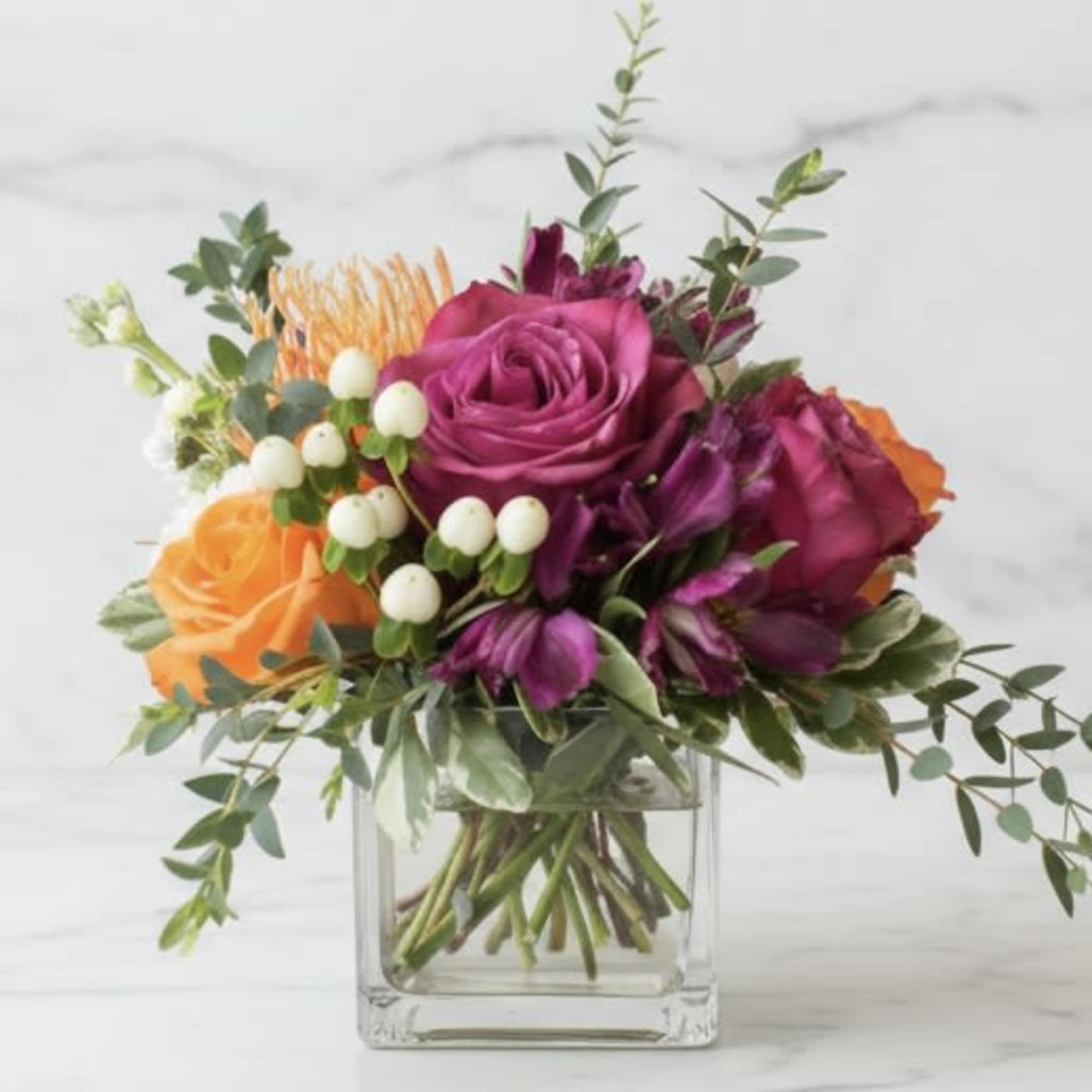 Our Nirvana Garden is a bright, jewel toned centerpiece of premium florals