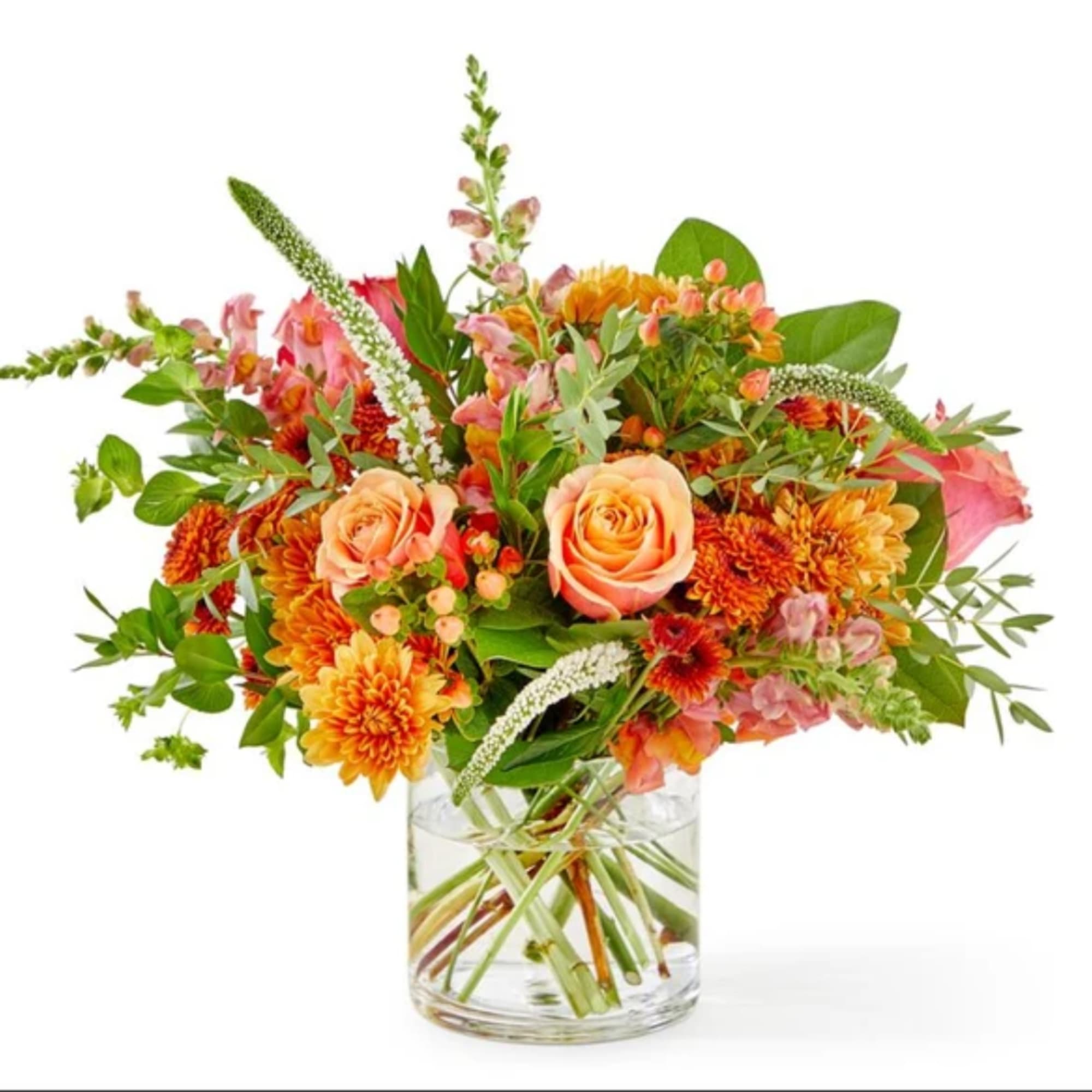 Orange and pink mixed bouquet in a clear glass vase