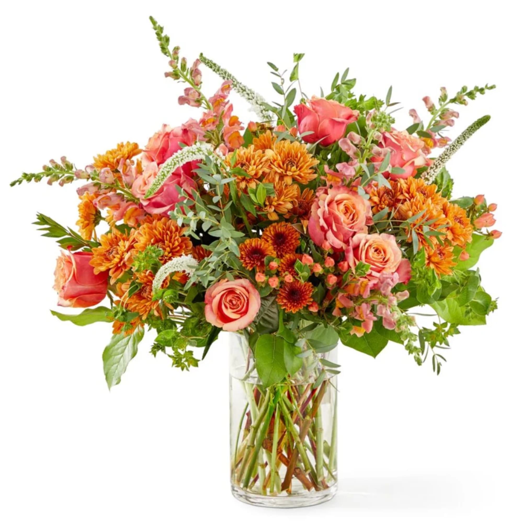 Bouquet of pink roses and orange chrysanthemums in a clear glass vase