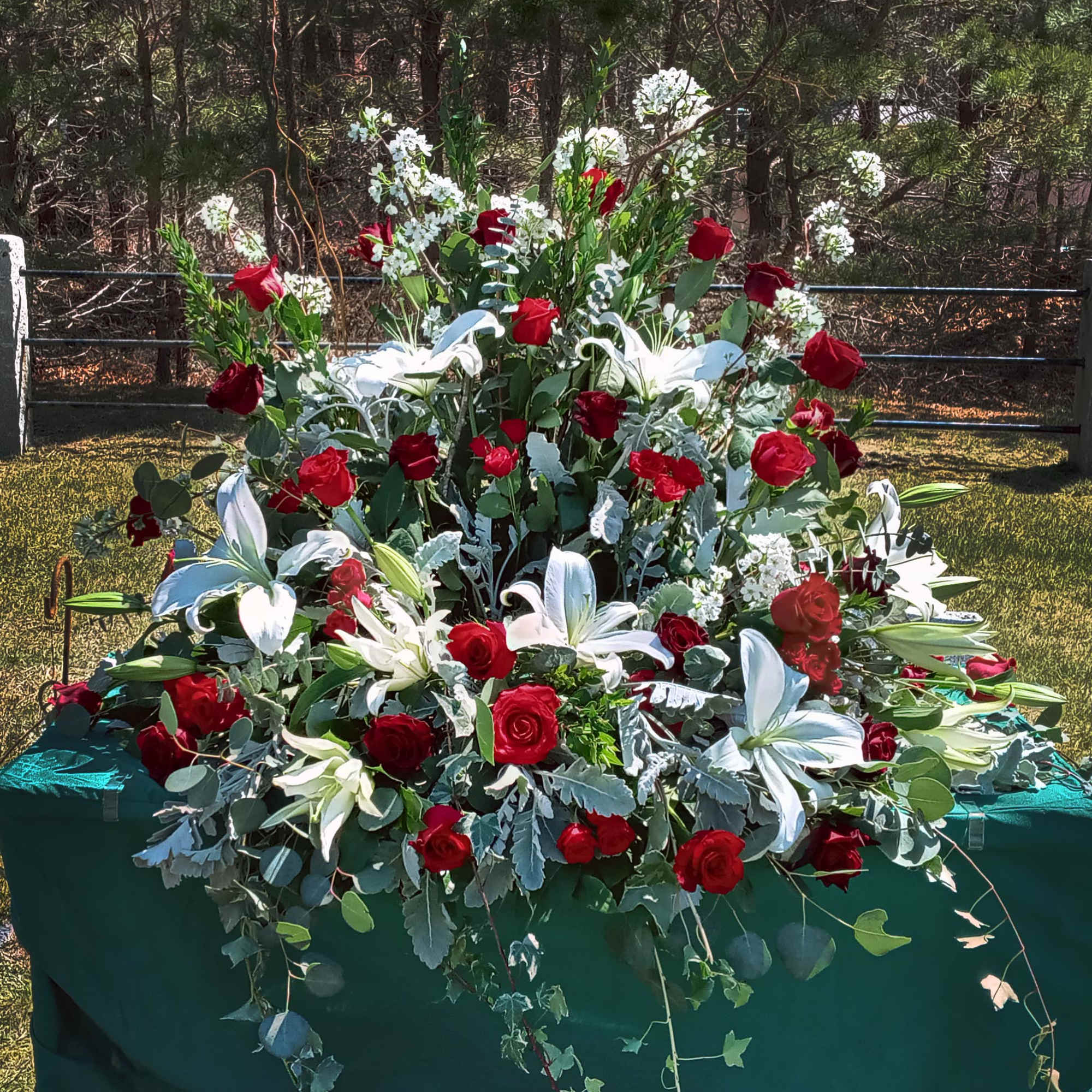 This arrangement surrounds the urn of your loved one with beautiful seasonal