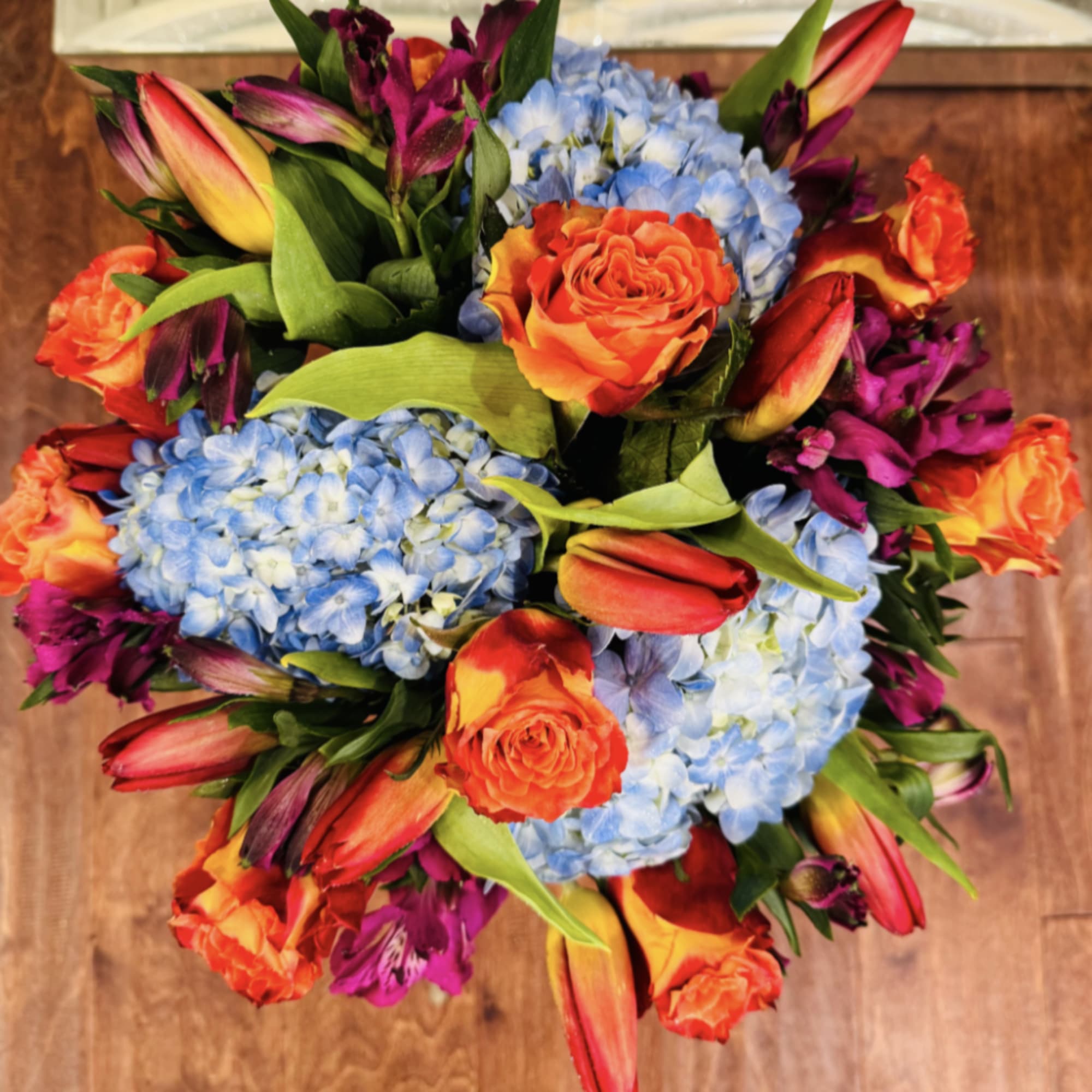 A bouquet with orange tulips, orange roses, blue hydrangeas, and pink asters, photo 4 of 4