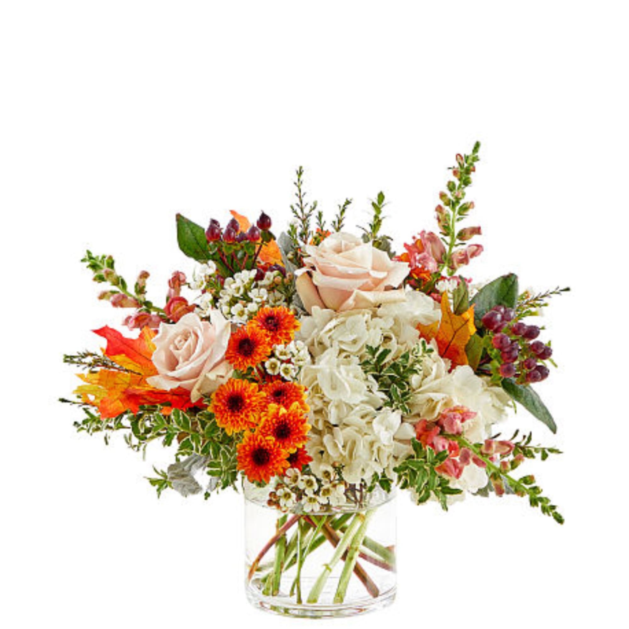 Mixed bouquet of roses, hydrangeas, and orange flowers in a glass vase