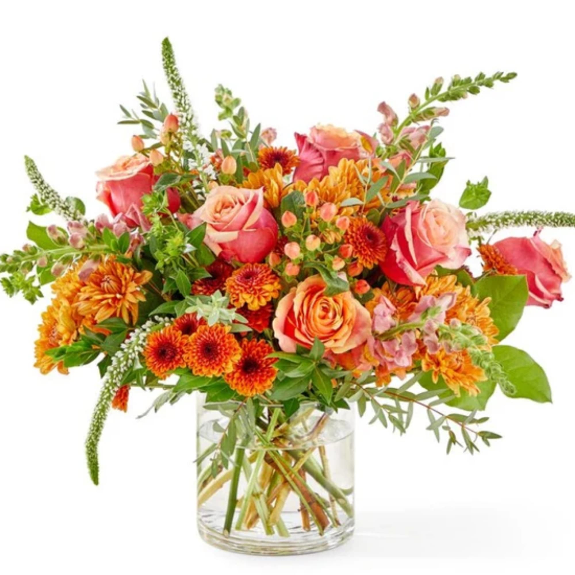 Mixed bouquet of roses and orange mums in a clear glass vase