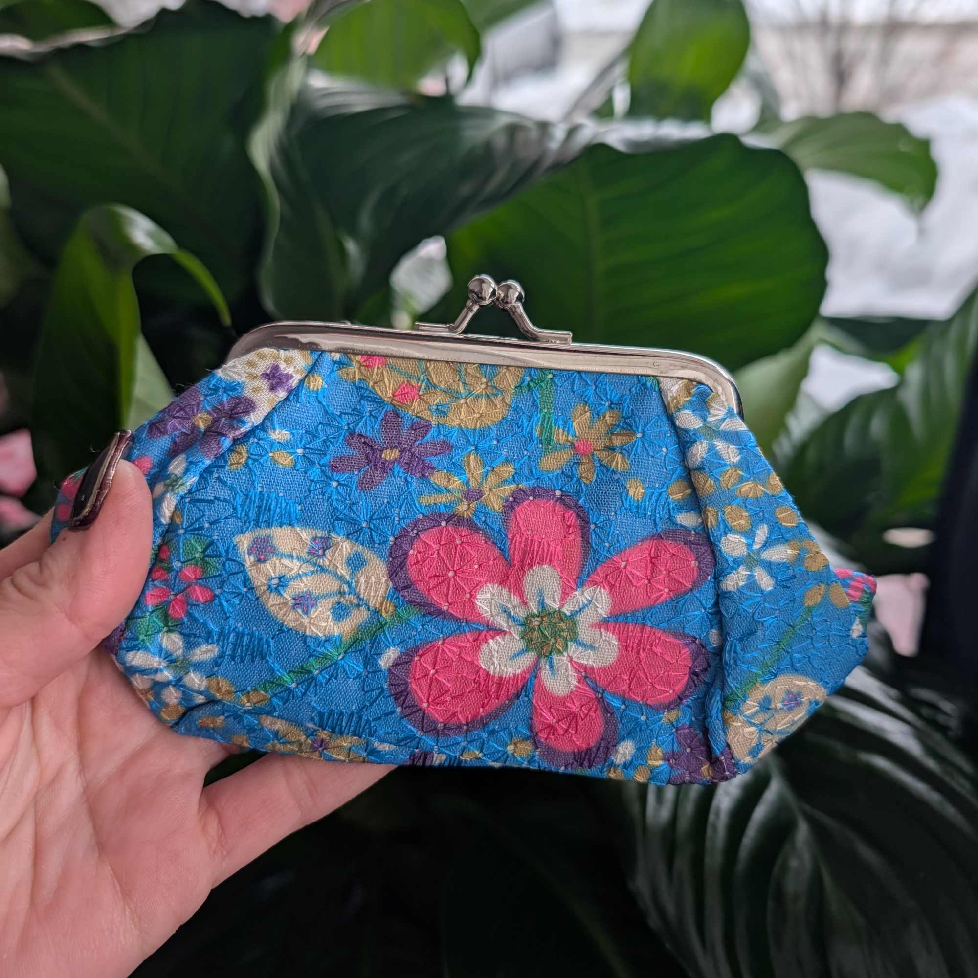 Floral-patterned blue coin purse with a metal clasp