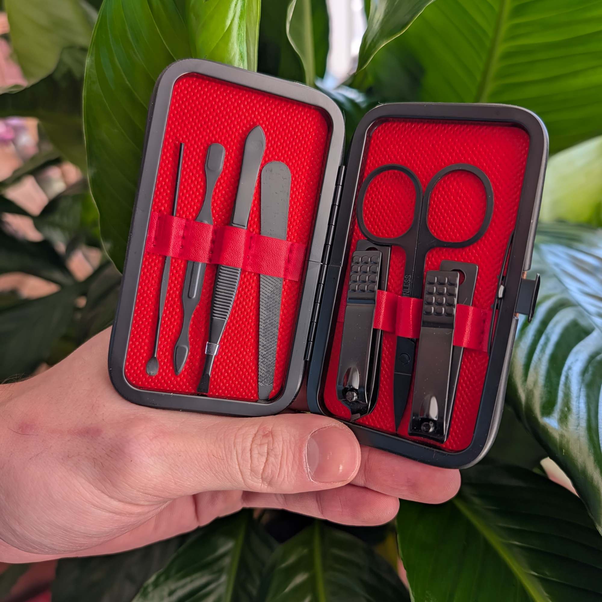 Manicure set in a red case held in a hand