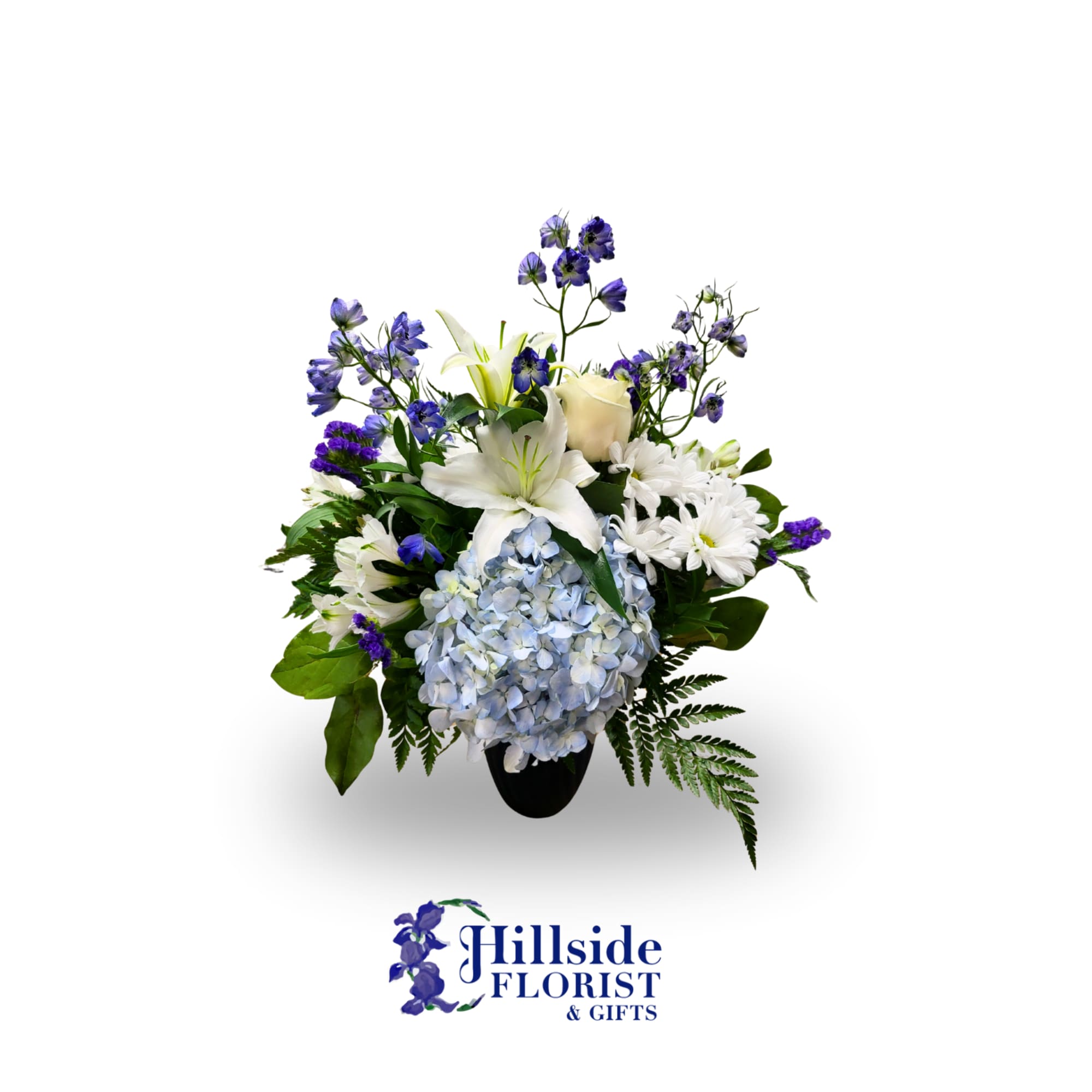 White lilies, blue hydrangea, and purple flowers in a black vase