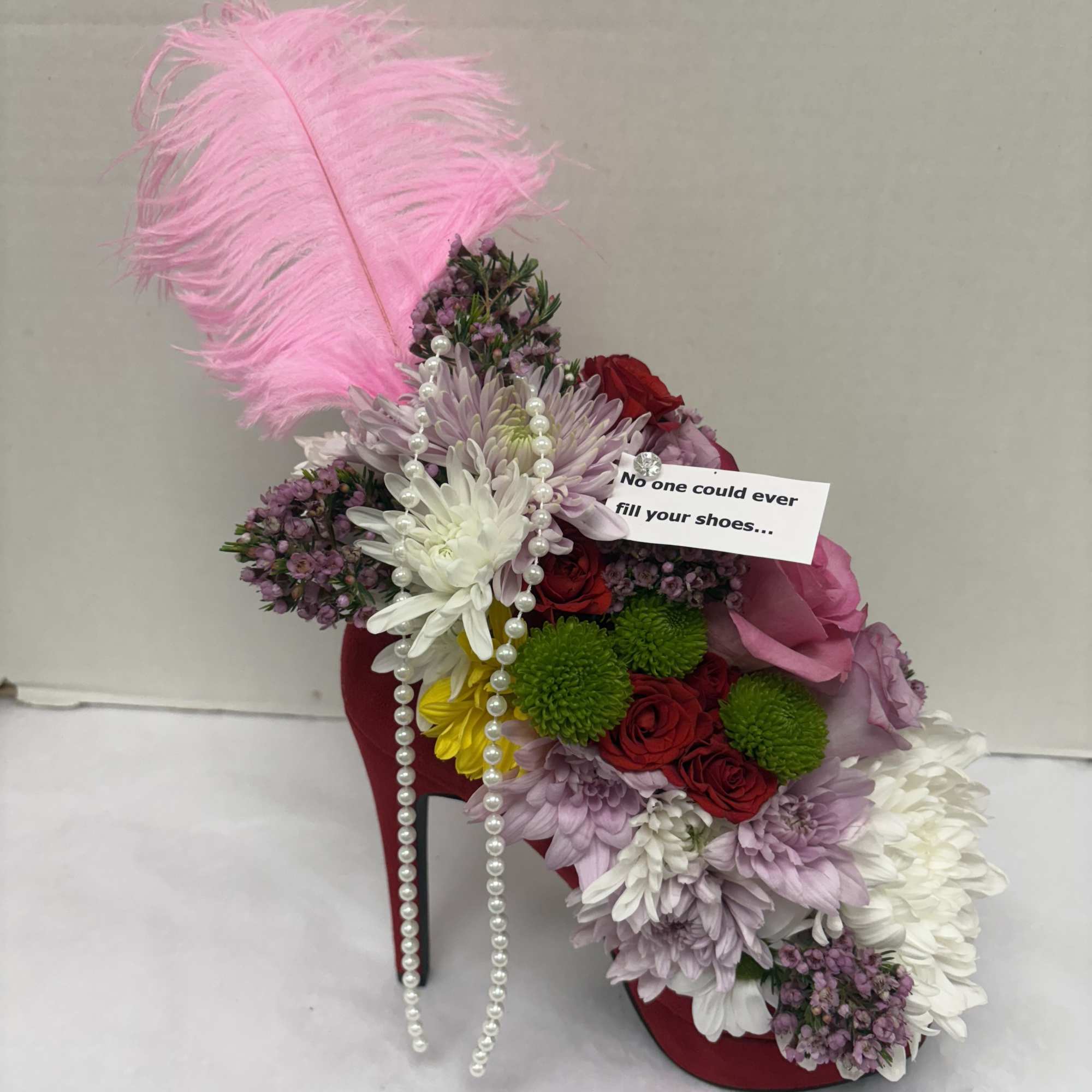 A unique custom flower arrangement in a real high heel shoe! No