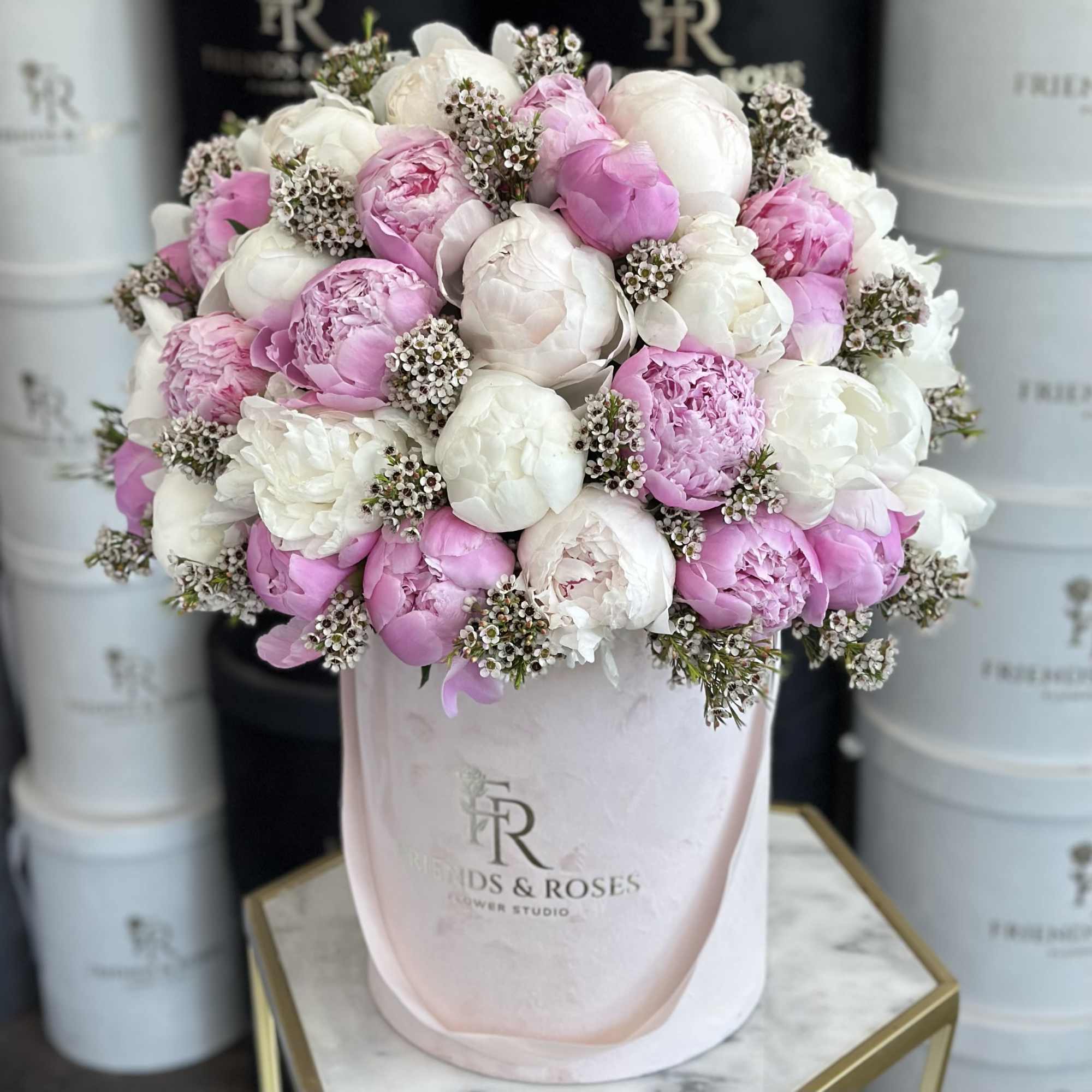 Pink and white peonies in a blush hatbox