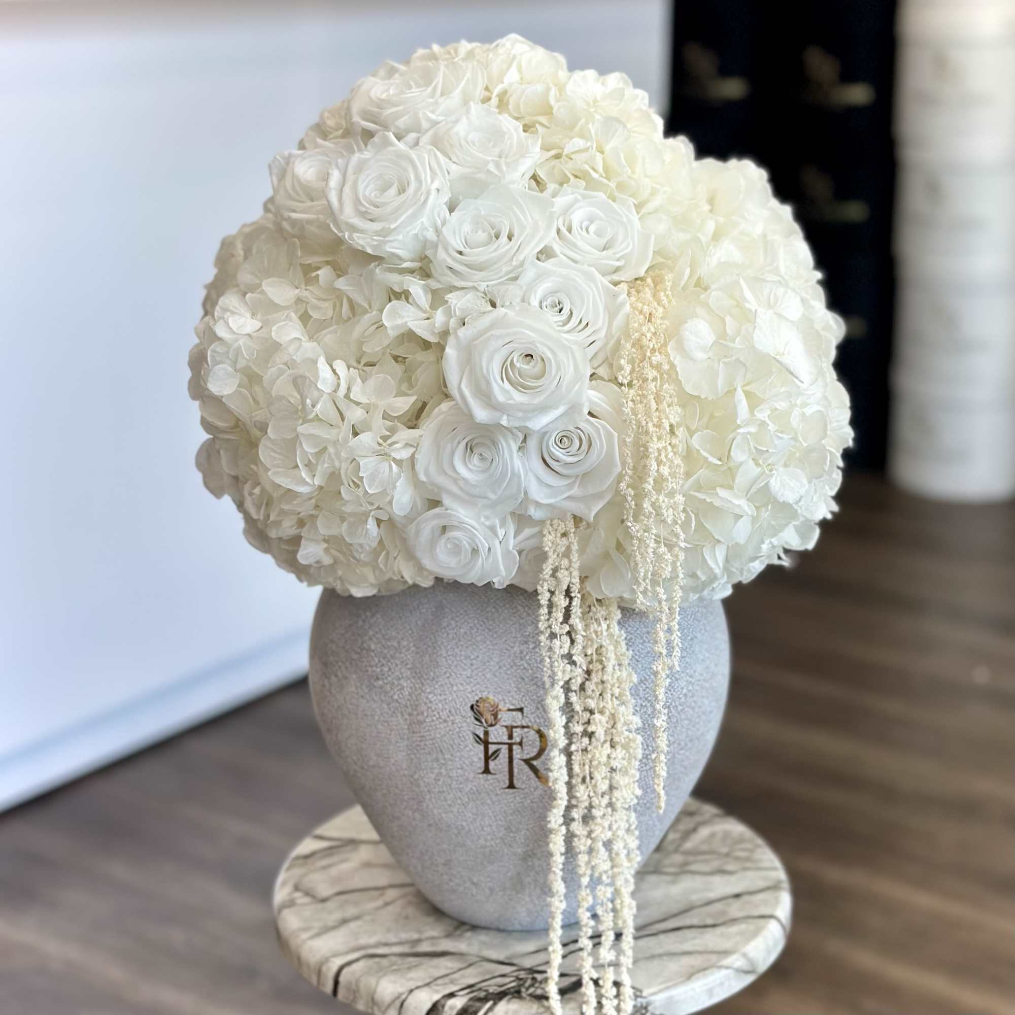 A breathtaking all-white arrangement designed to embody sophistication and serenity. Featuring lush, photo 2 of 3