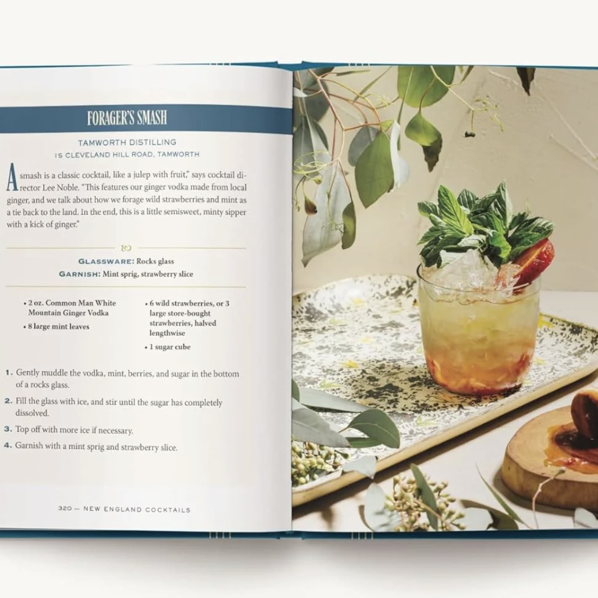 Open cookbook showing a cocktail recipe and a garnished drink on a tray