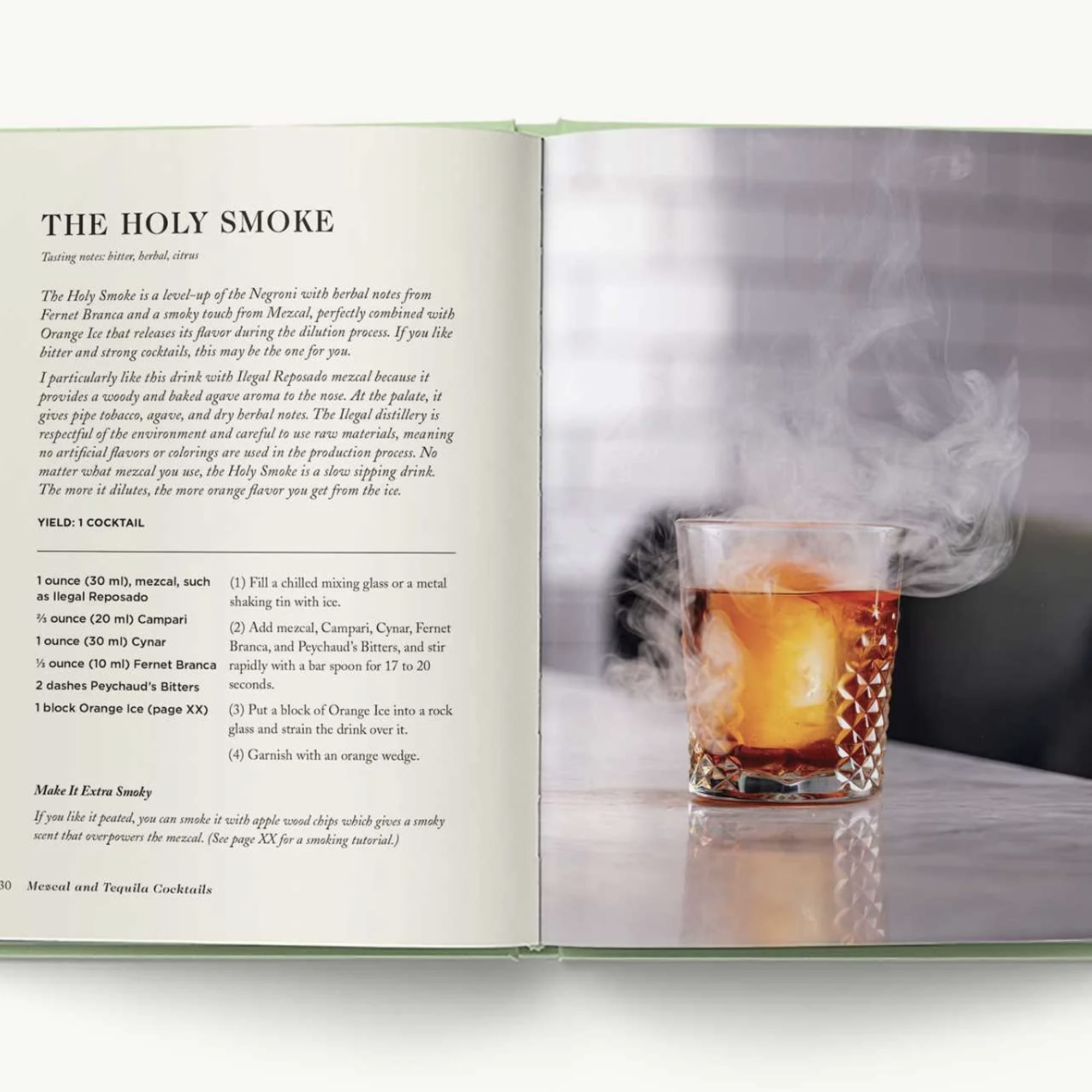Open book showing a smoky cocktail recipe and a glass of amber drink