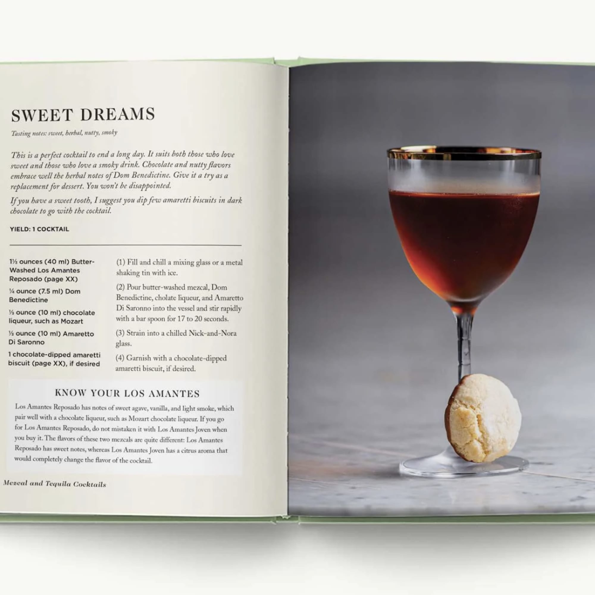 Open cookbook showing a dark cocktail in a stemmed glass with a cookie garnish