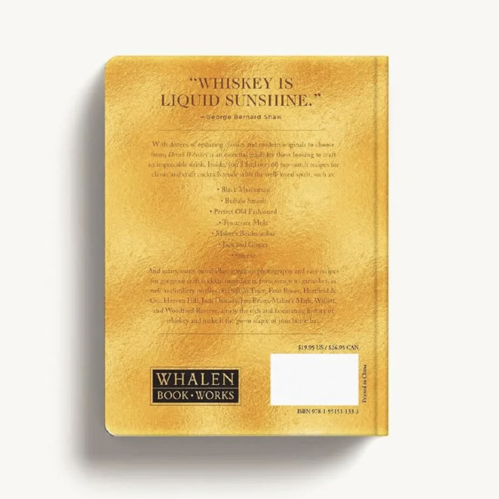Yellow hardcover book with whiskey-themed text on the cover