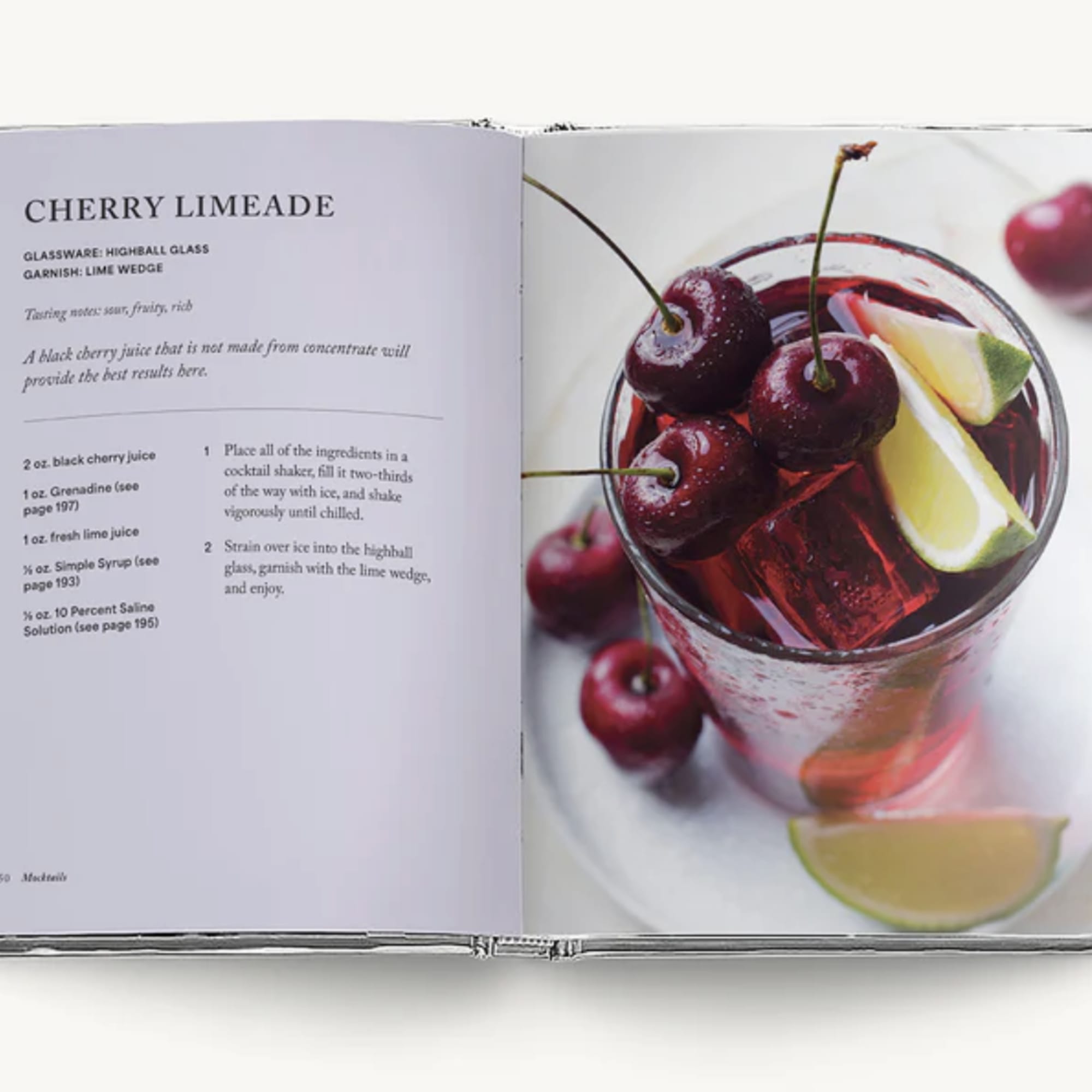 Open cookbook showing a cherry limeade recipe and a photo of the drink