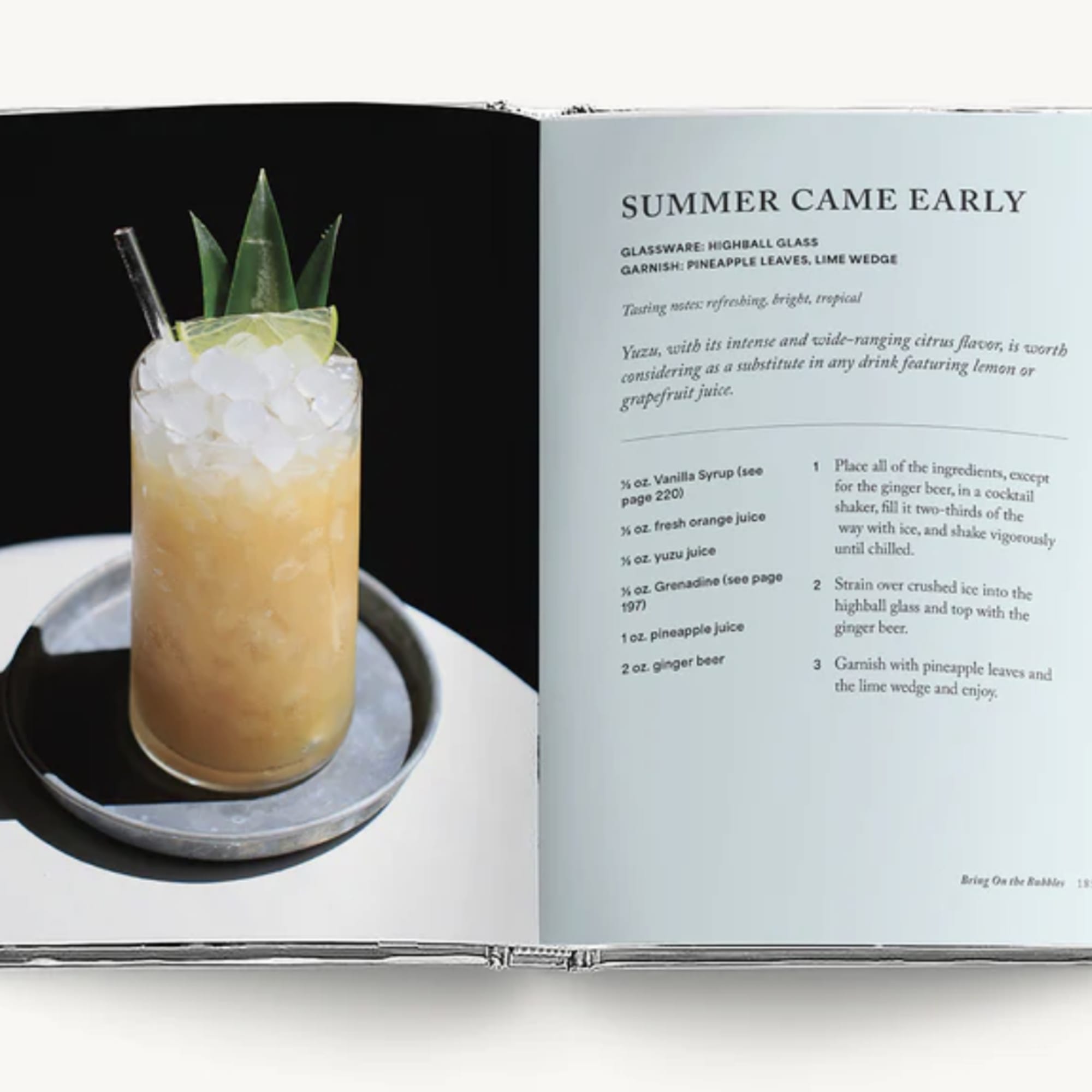 Open cookbook showing a tropical cocktail in a glass
