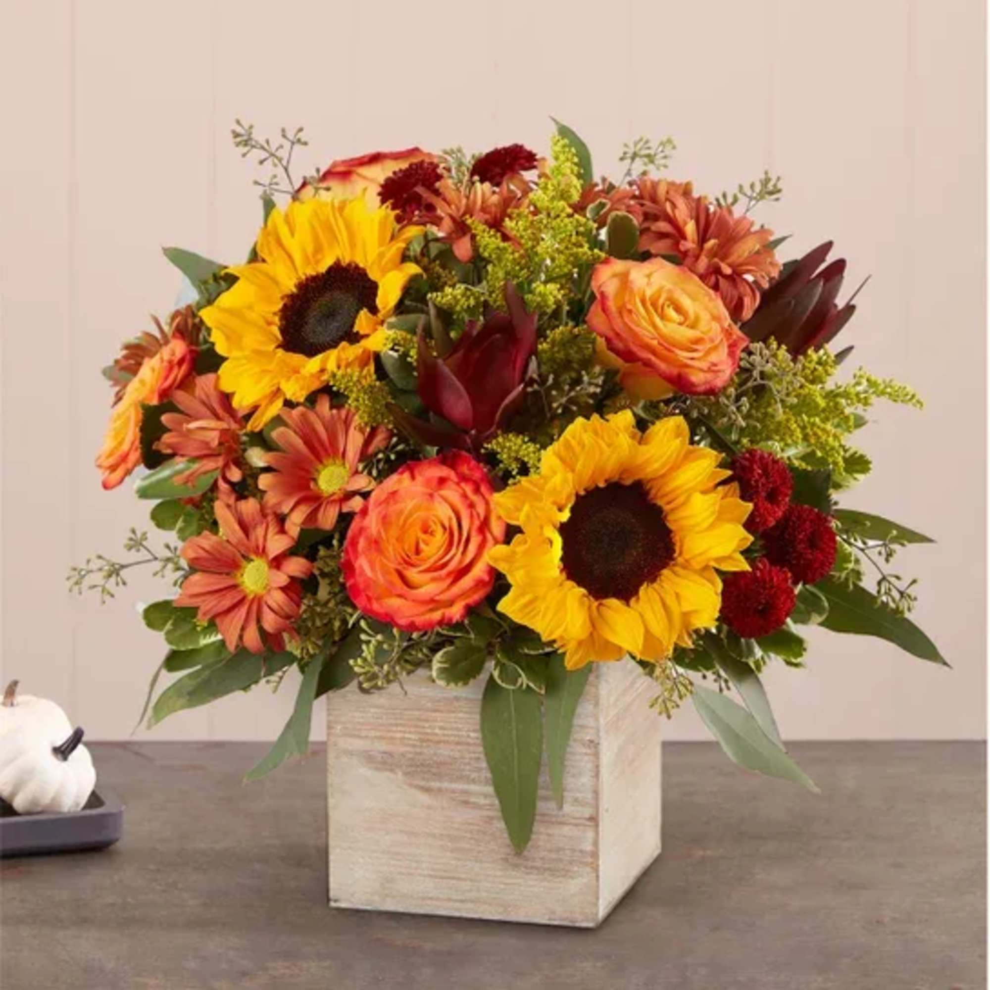 Mixed bouquet of sunflowers, roses, and mums in a wooden cube vase