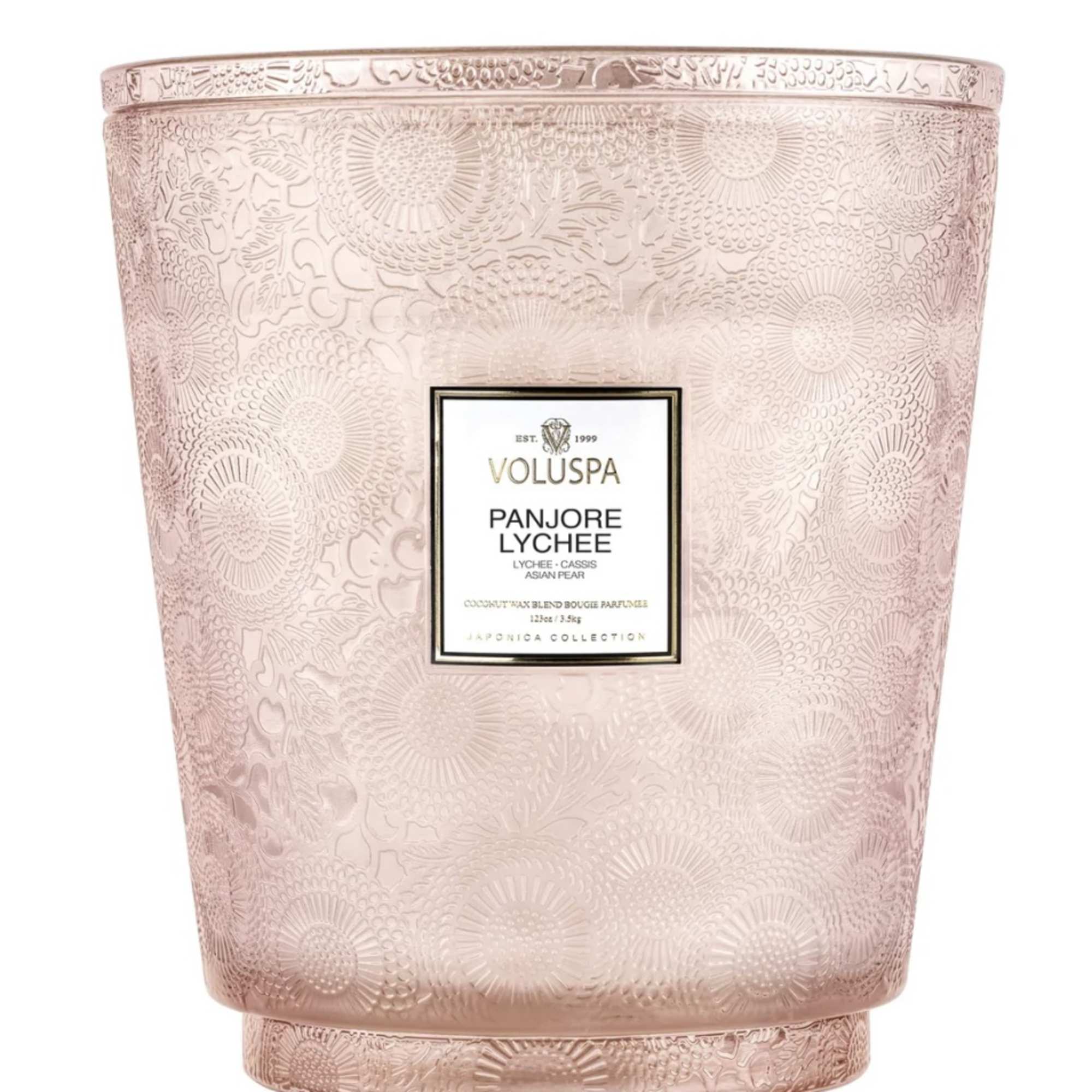 Pink patterned candle in a decorative glass vessel