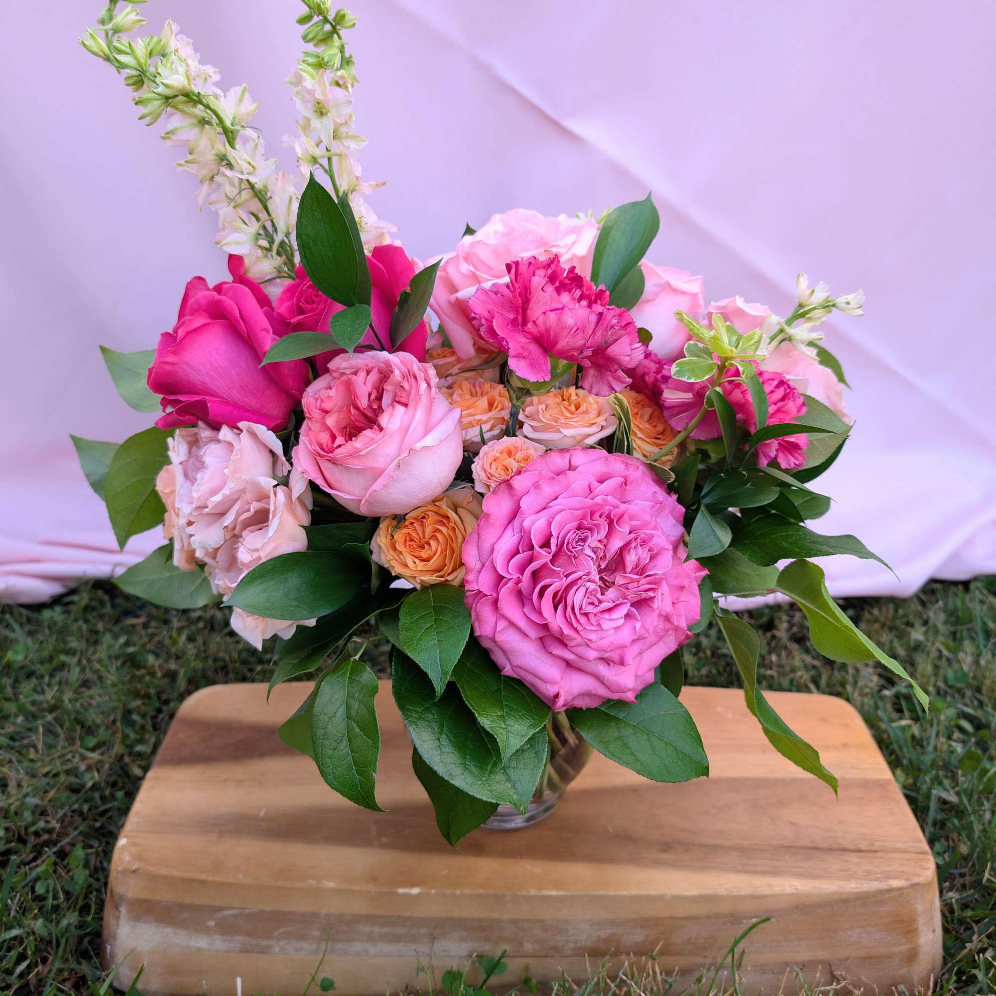 Pink and peach rose bouquet in a clear glass vase