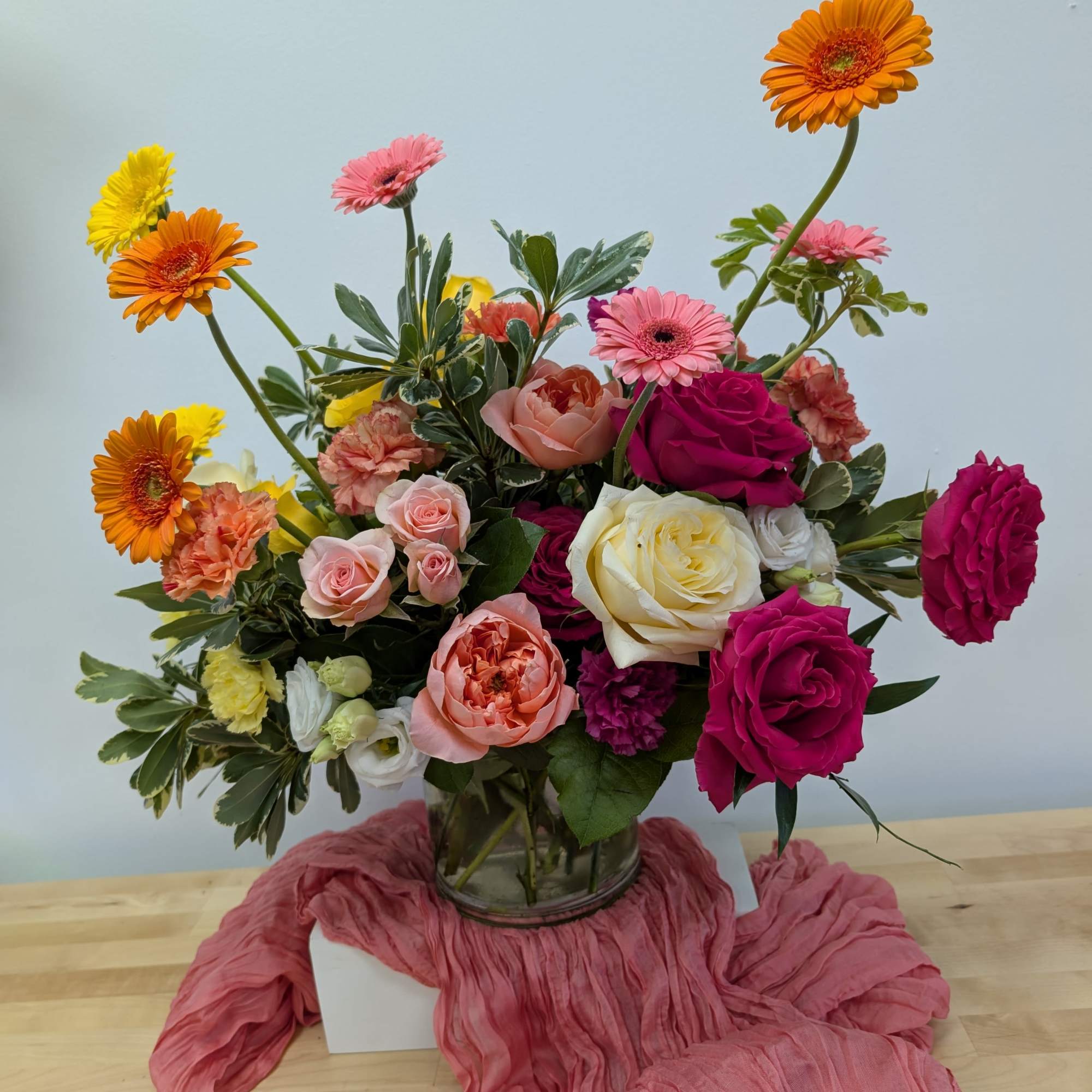 Mixed bouquet of roses, gerbera daisies, and carnations in a glass vase, photo 3 of 6