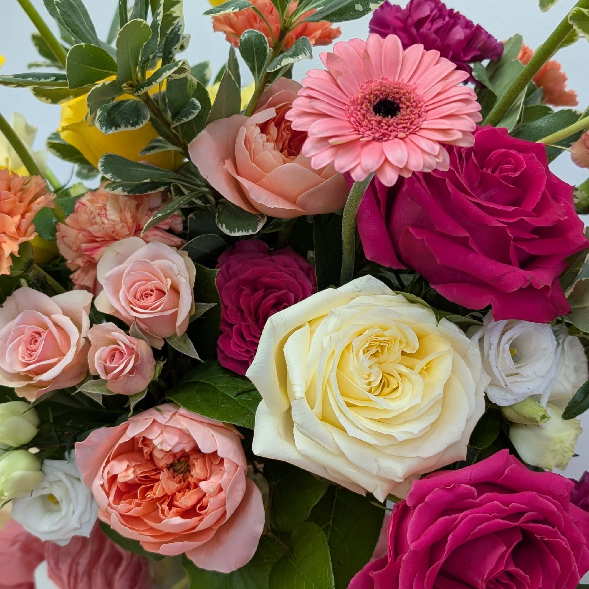 Mixed bouquet of roses, gerbera daisies, and carnations in a glass vase, photo 4 of 6
