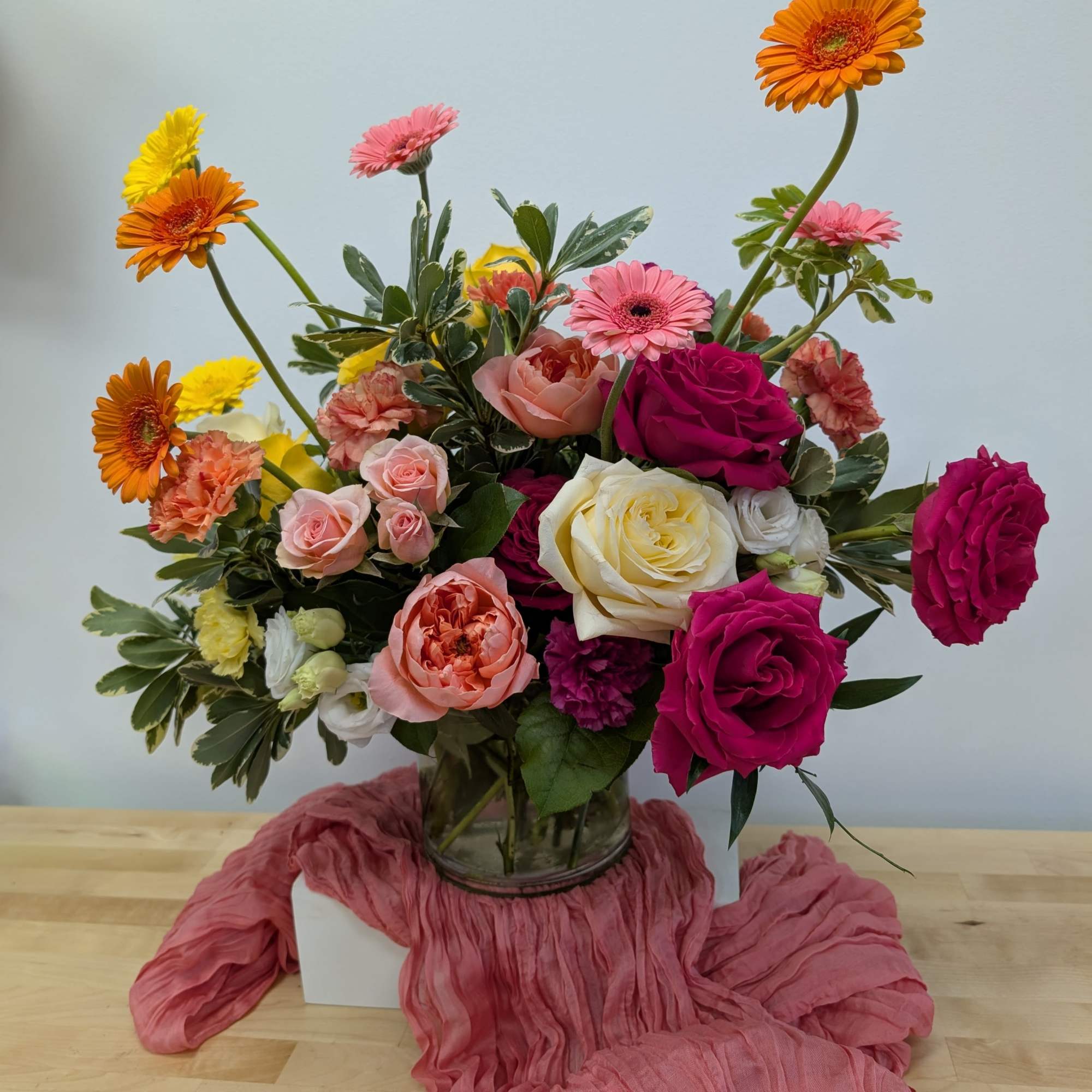 Mixed bouquet of roses, gerbera daisies, and carnations in a glass vase, photo 5 of 6