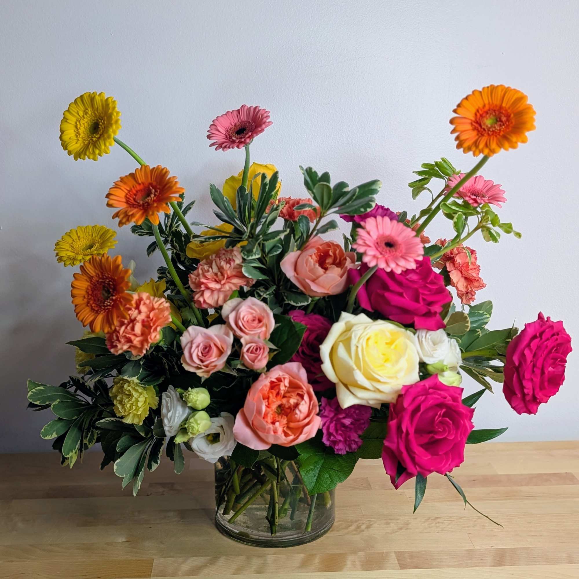 Mixed bouquet of roses, gerbera daisies, and carnations in a glass vase, photo 6 of 6