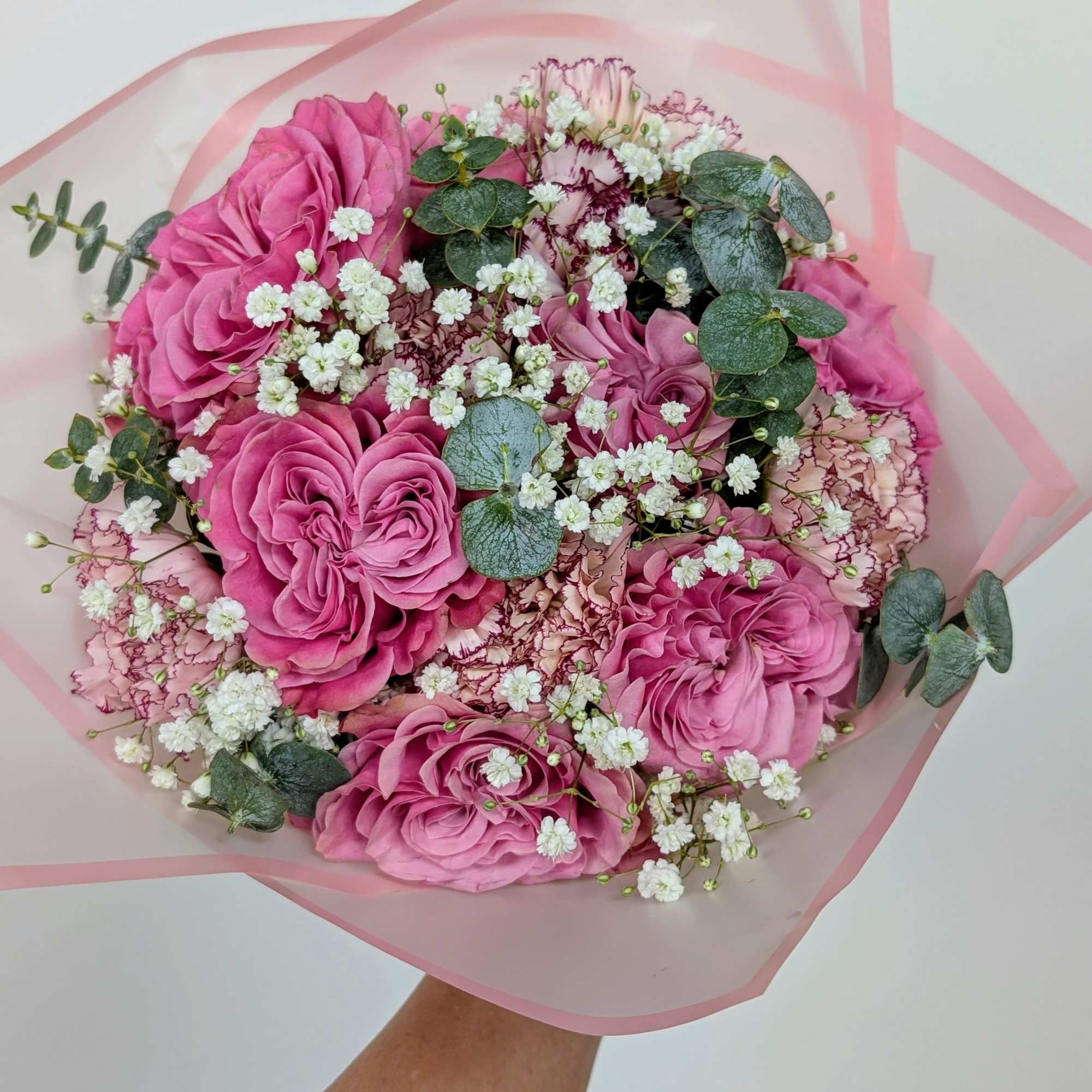 Pink rose bouquet with white baby's breath and eucalyptus in pink wrap