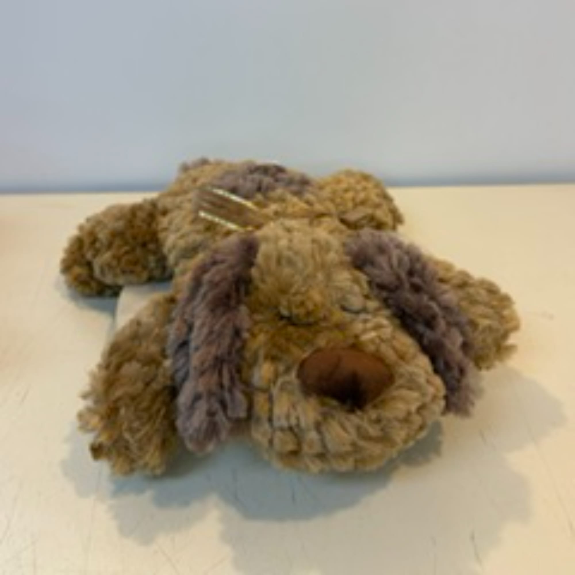 Plush teddy bear lying on a table
