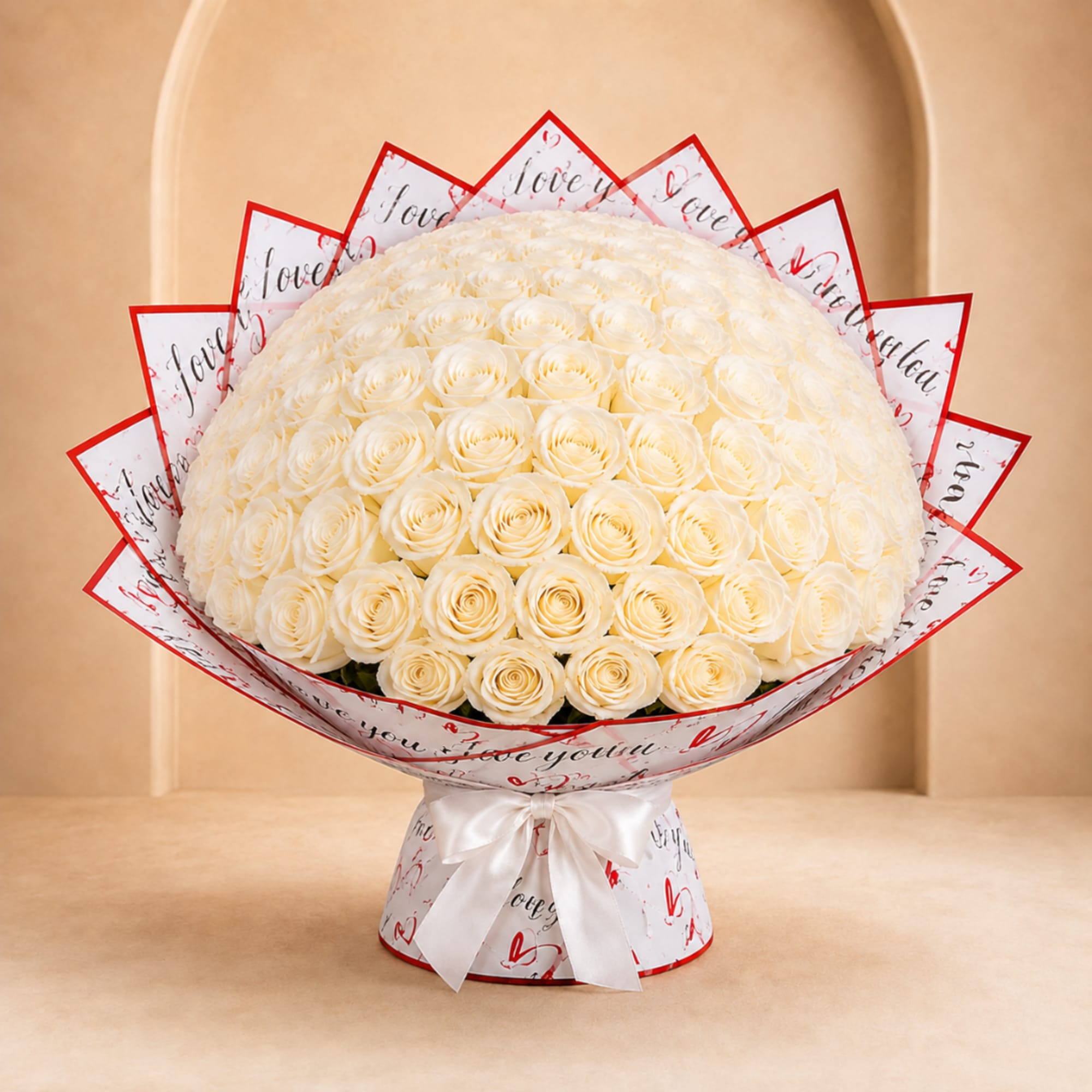 Large bouquet of cream roses wrapped in white paper with red heart accents