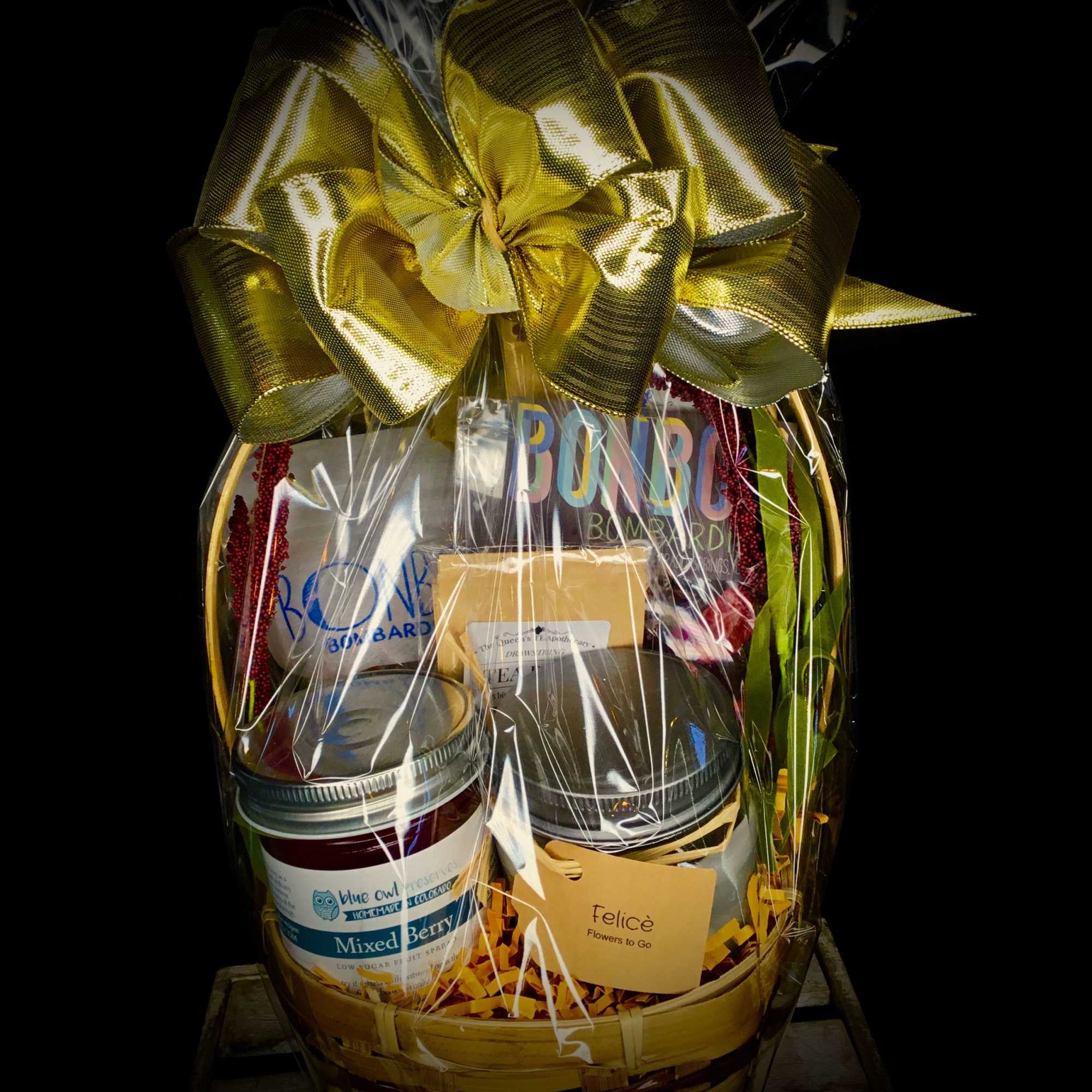 Gift basket with jars and a large gold bow