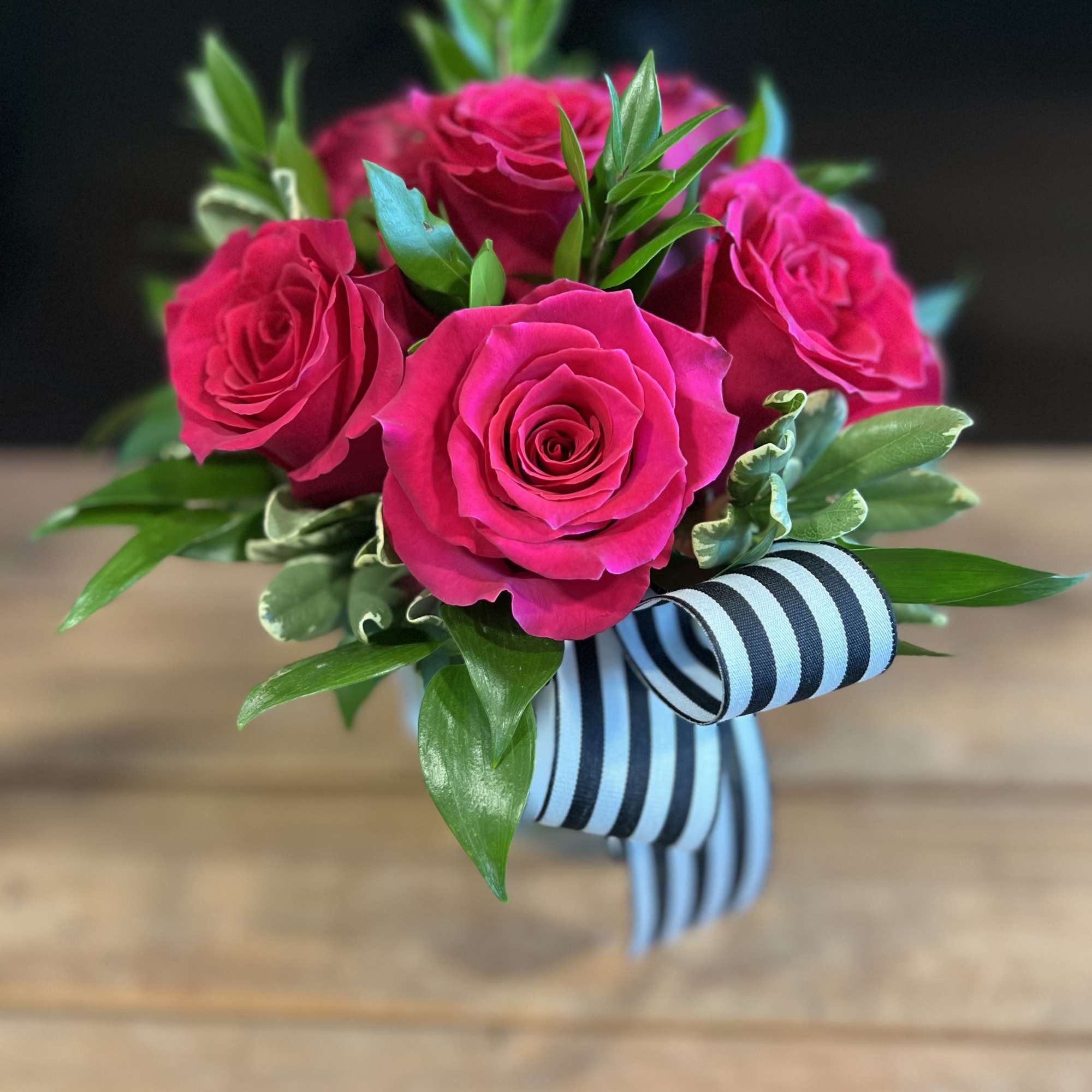 Bouquet of hot pink roses with a striped ribbon